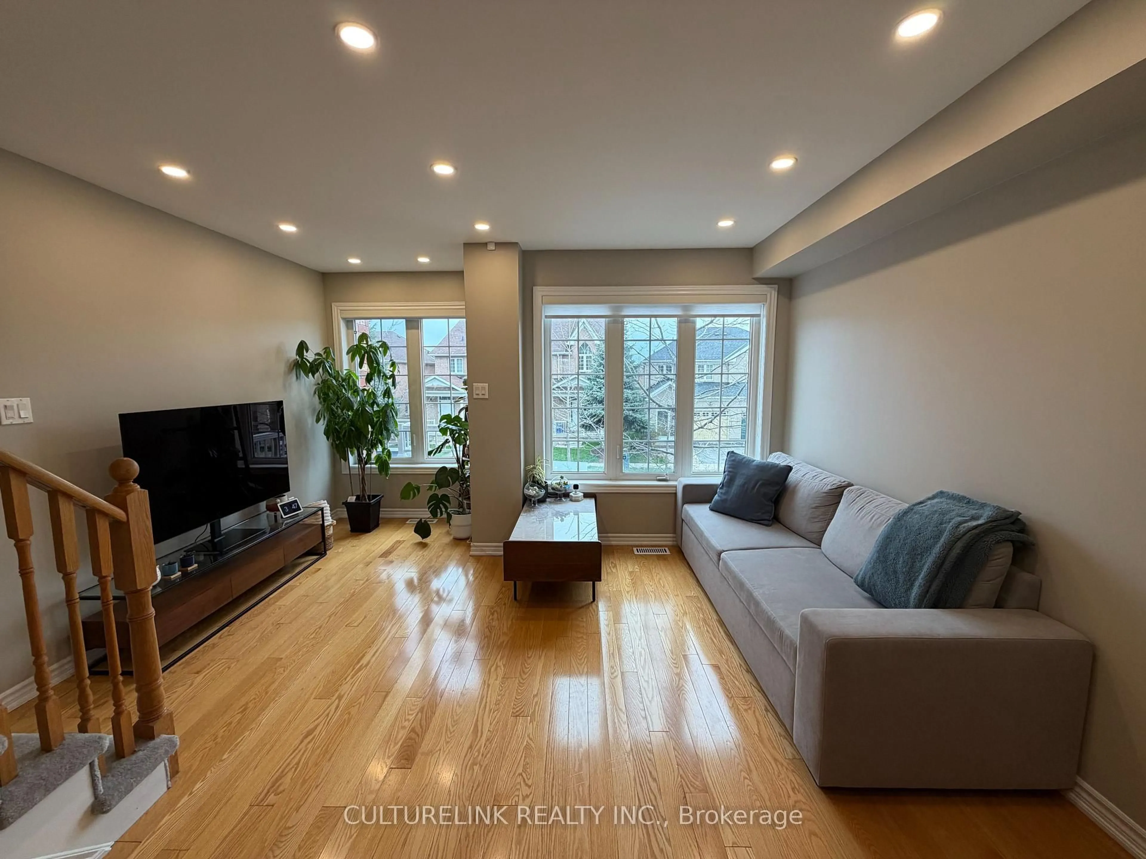 Living room with furniture, wood/laminate floor for 345 Caboto Tr, Markham Ontario L3R 5G6