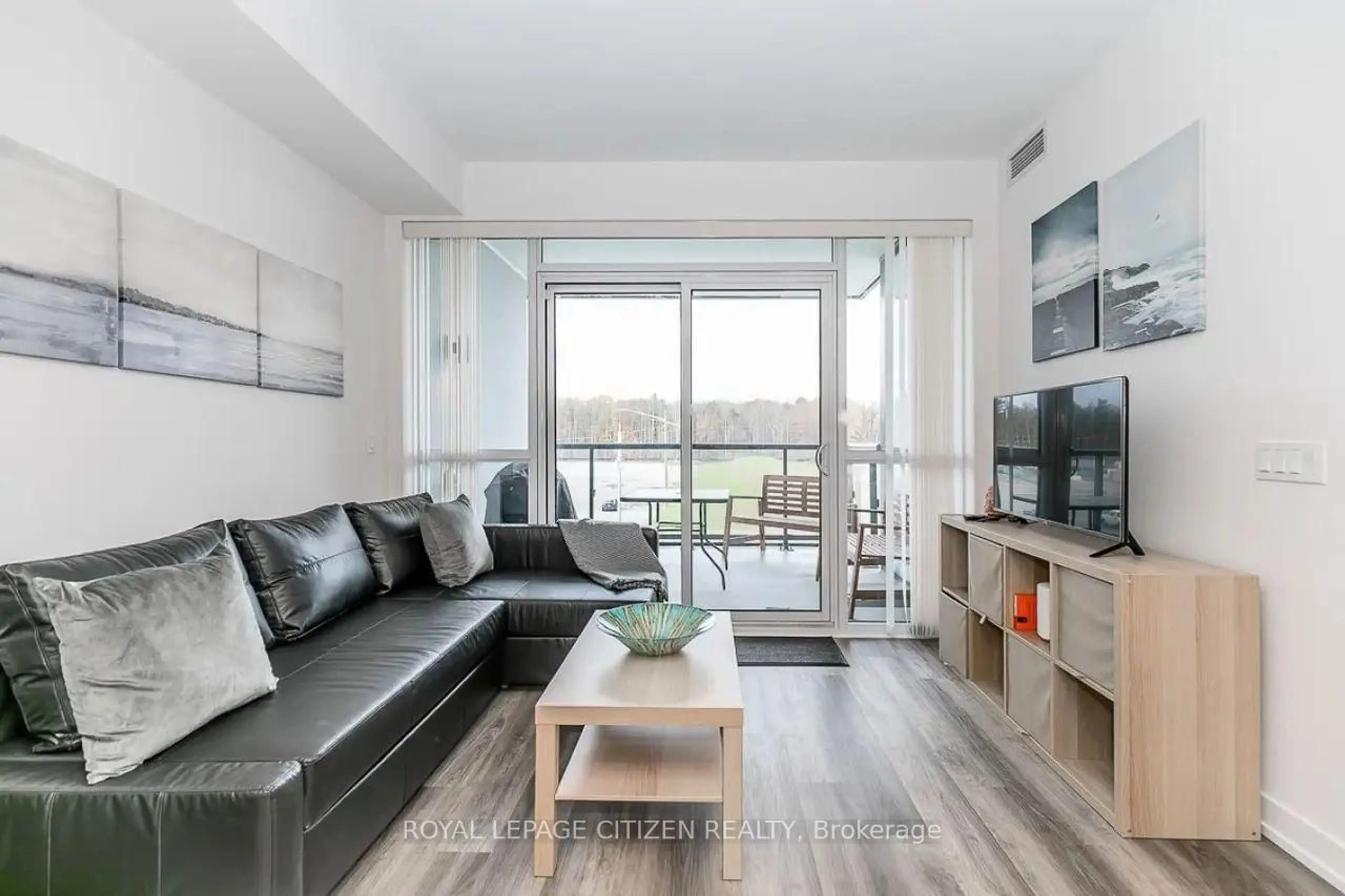 Living room with furniture, wood/laminate floor for 415 Sea Ray Ave #306, Innisfil Ontario L9S 0R5