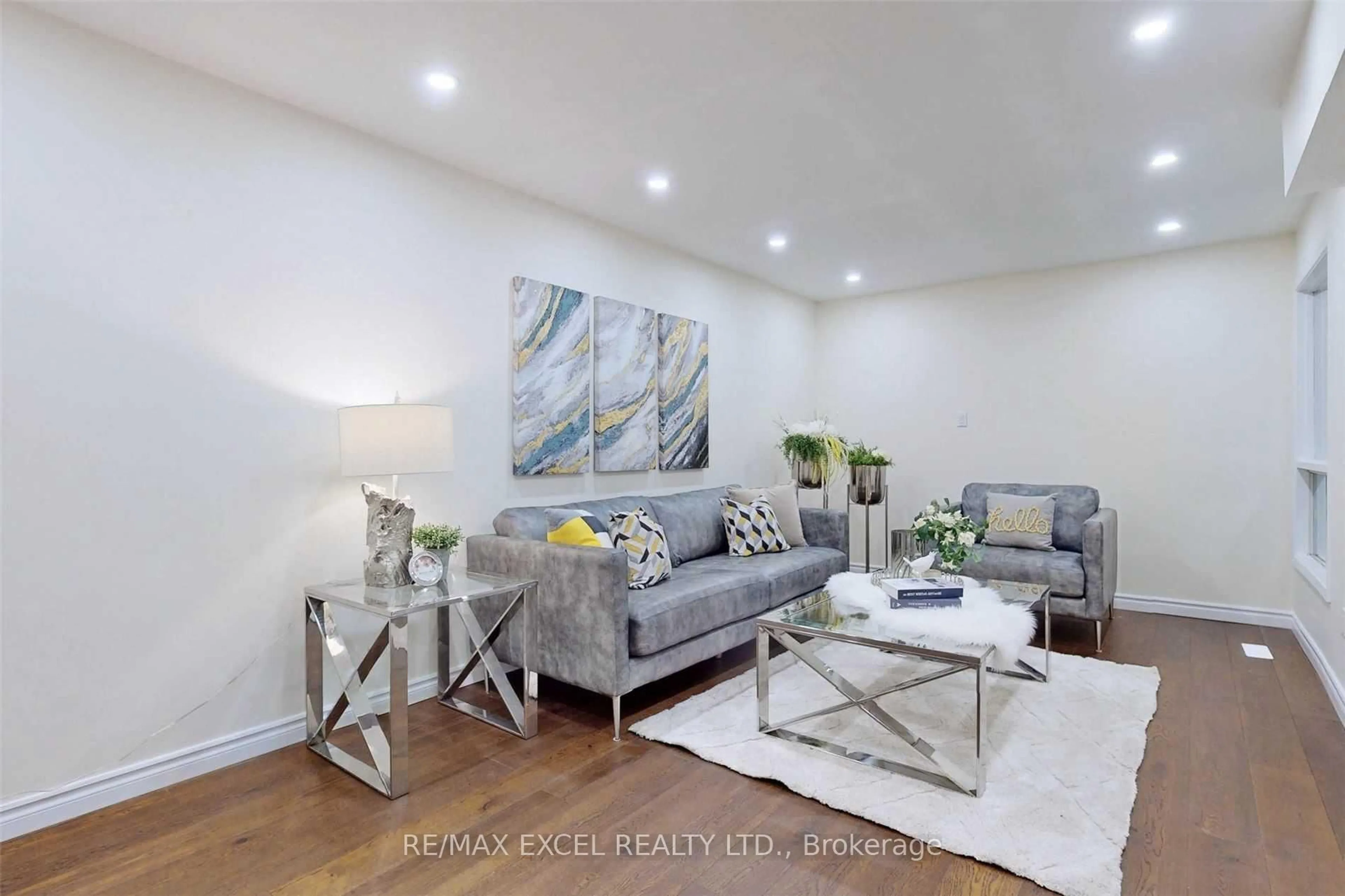 Living room with furniture, wood/laminate floor for 28 Karen Miles Cres, Markham Ontario L3S 1Z6