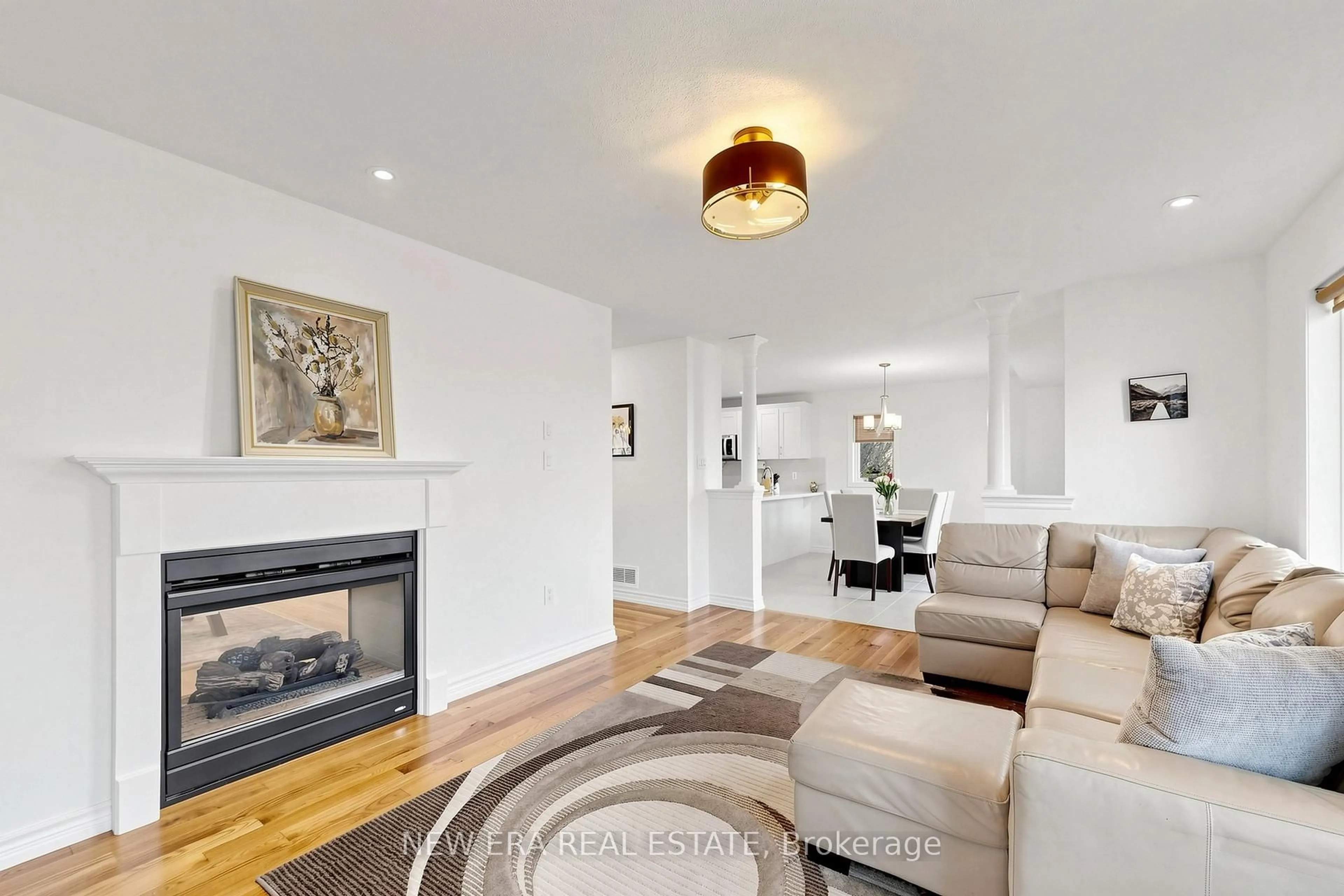 Living room with furniture, wood/laminate floor for 61 Orville Hand Crt, Bradford West Gwillimbury Ontario L3Z 0C2