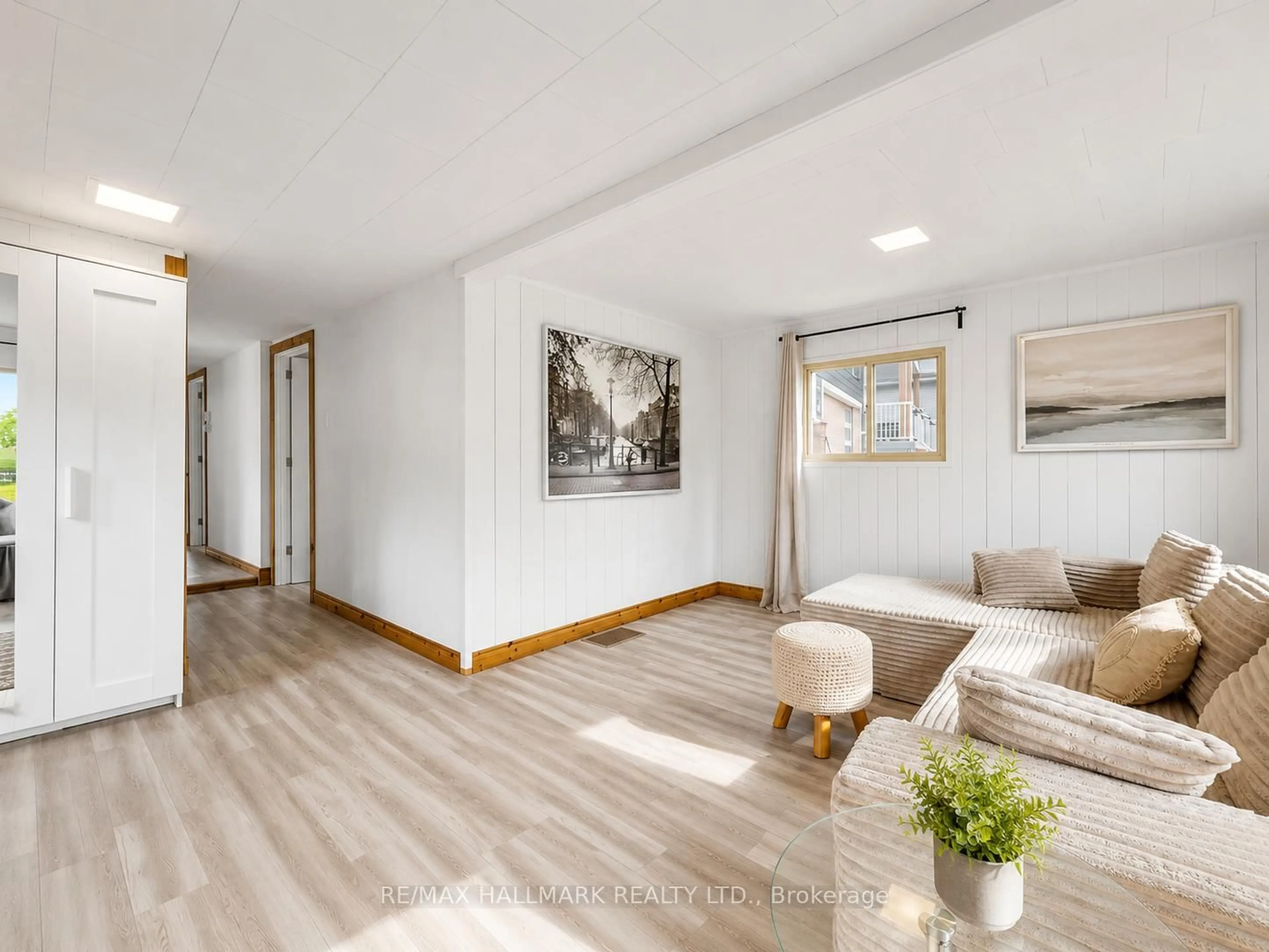 Living room with furniture, wood/laminate floor for 1053 Elm Rd, Innisfil Ontario L0L 1C0