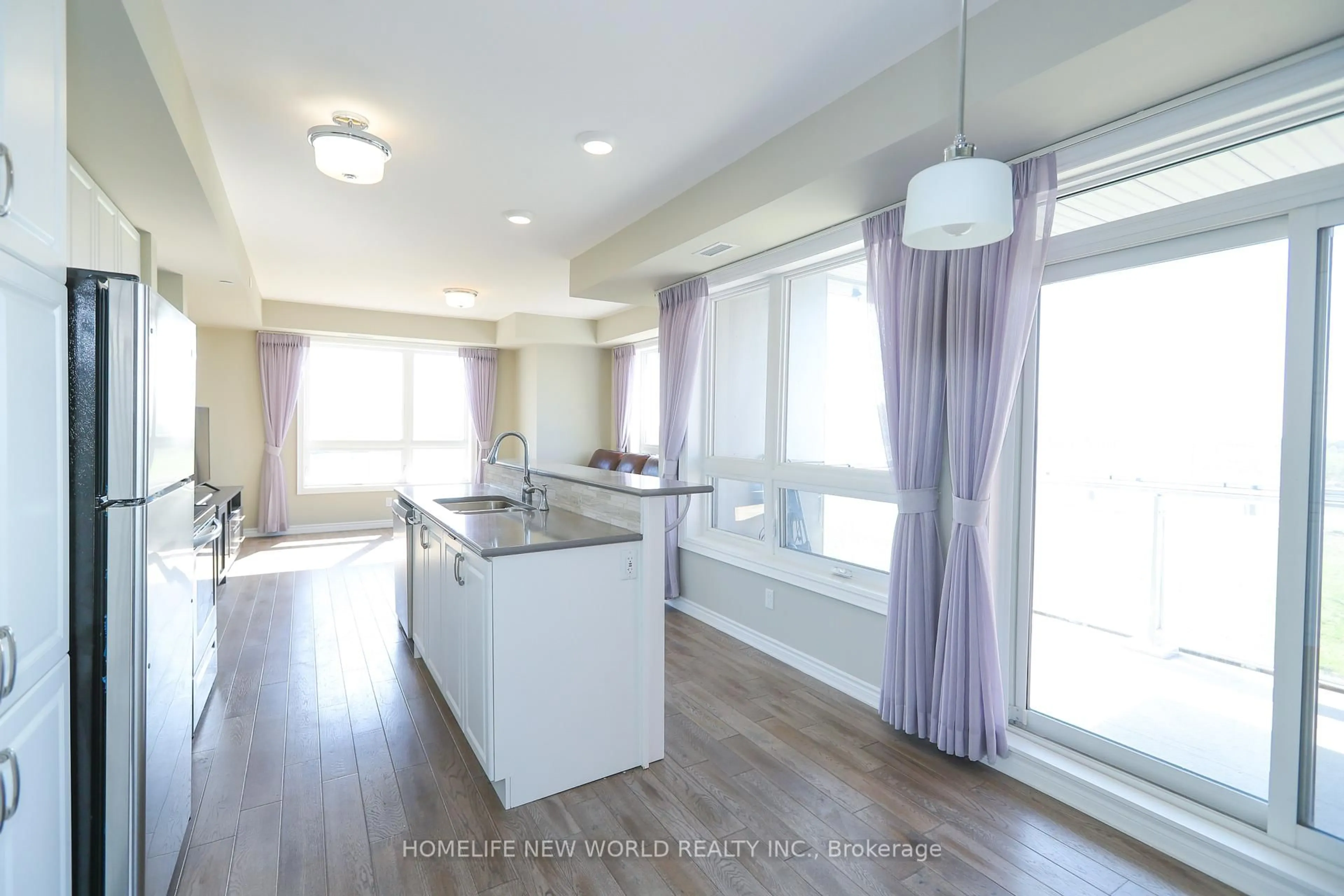 Open concept kitchen, wood/laminate floor for 2 Adam Sellers St #405, Markham Ontario L6B 1P5