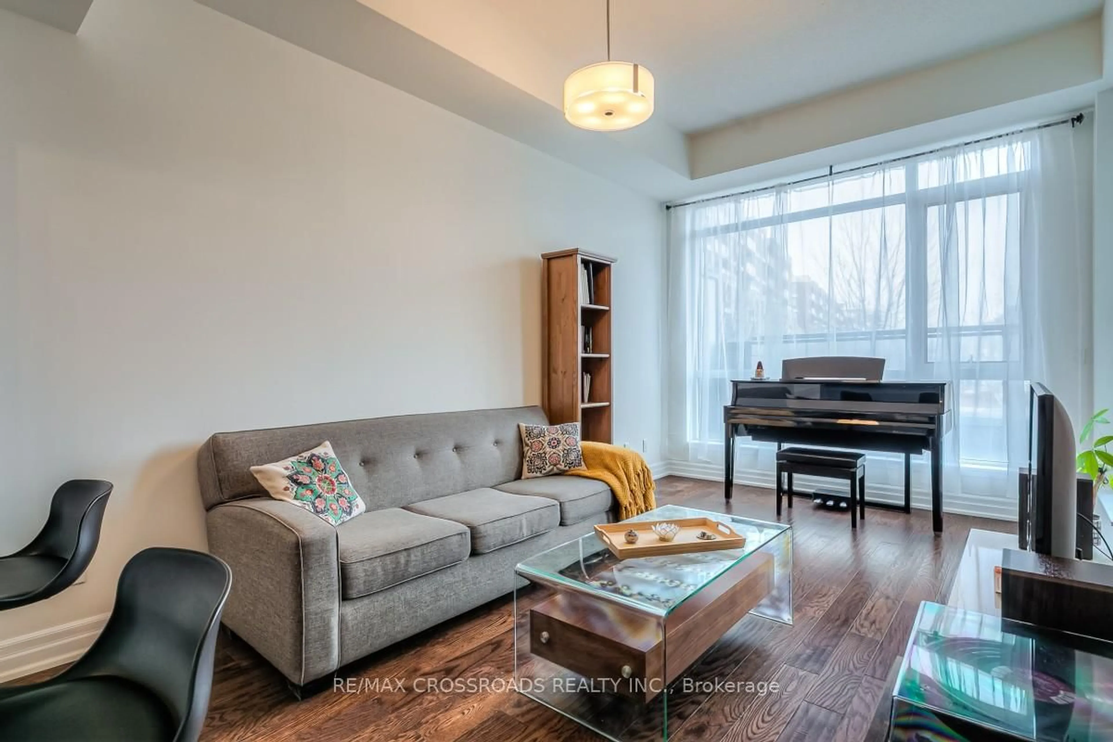 Living room with furniture, wood/laminate floor for 8110 Birchmount Rd #203, Markham Ontario L6G 0E3