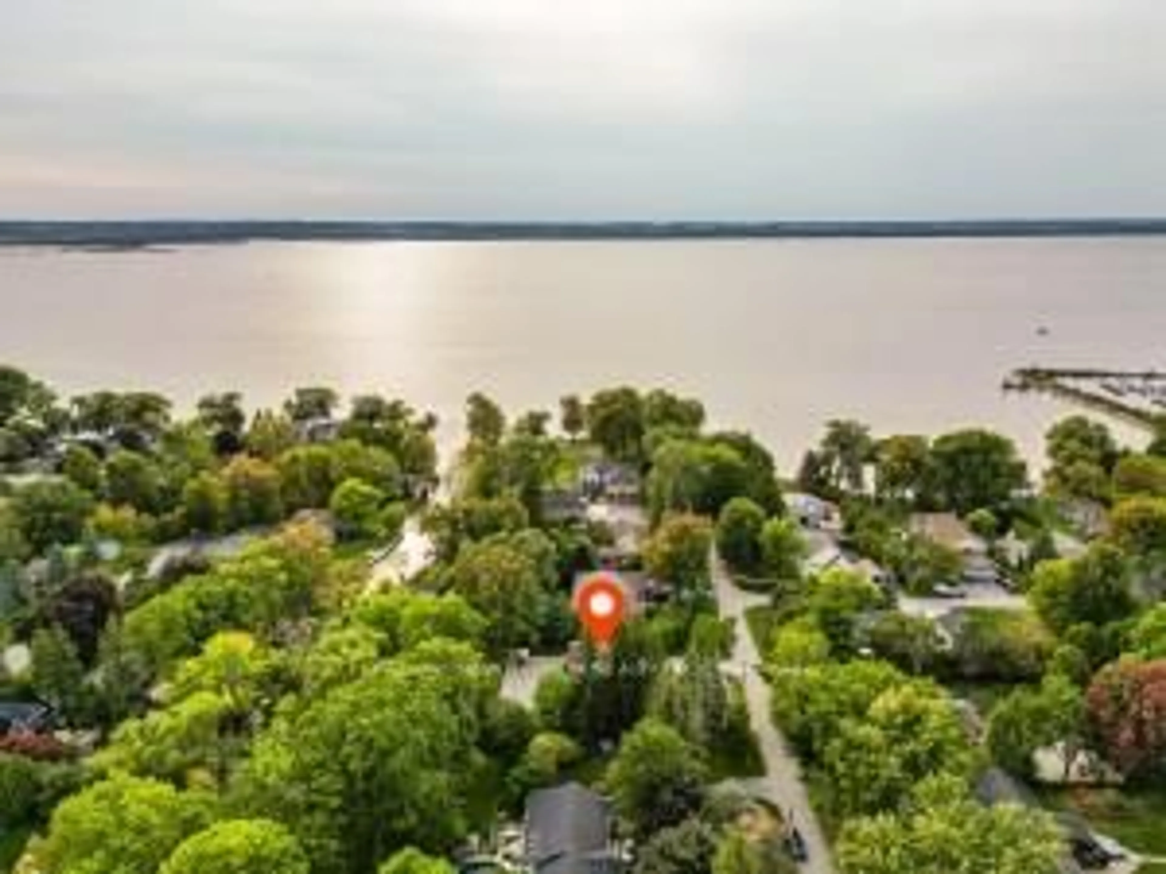 A pic from outside/outdoor area/front of a property/back of a property/a pic from drone, water/lake/river/ocean view for 215 Willow Dr, Georgina Ontario L4P 2R9