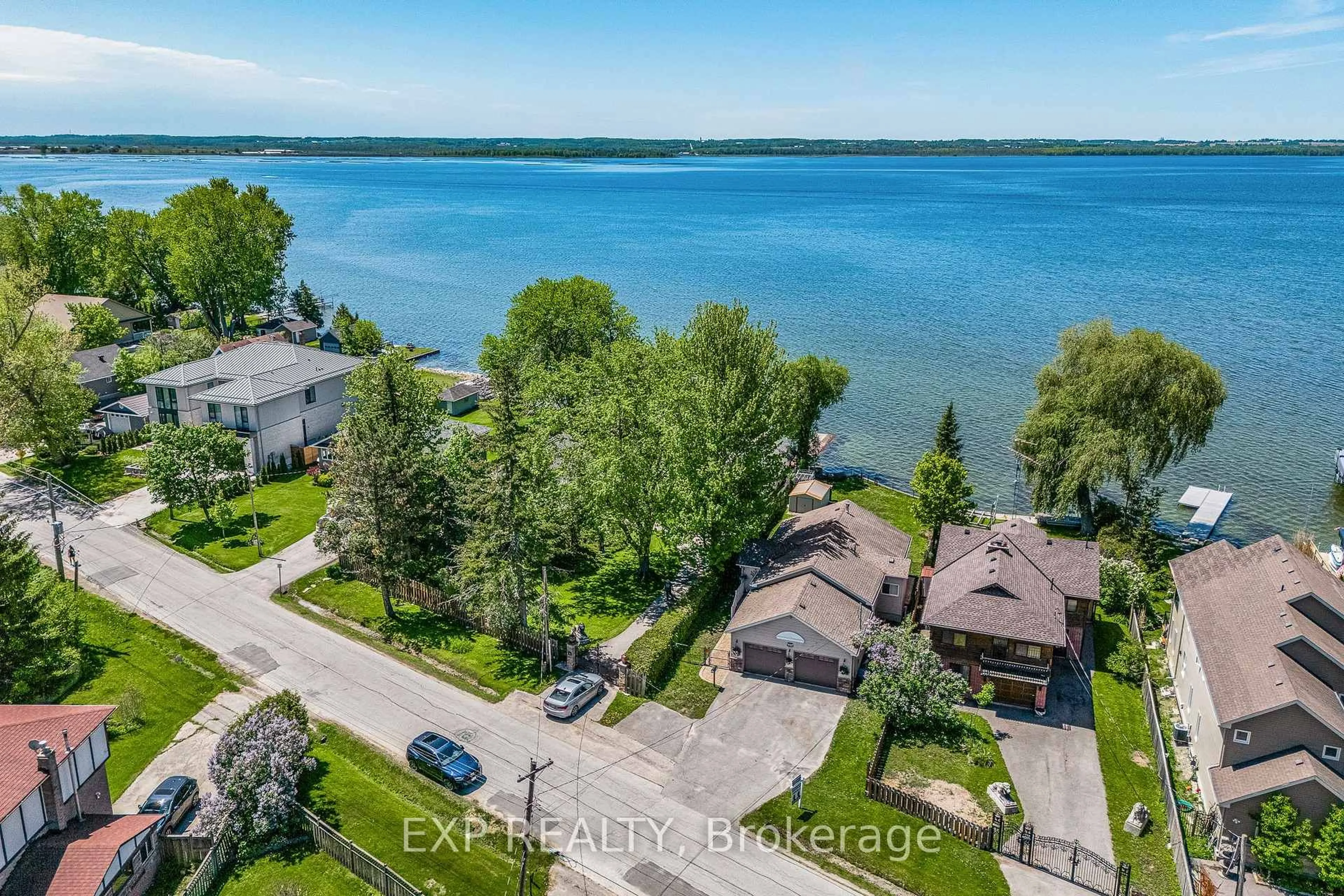 A pic from outside/outdoor area/front of a property/back of a property/a pic from drone, water/lake/river/ocean view for 450 Lake Dr, Georgina Ontario L4P 1P9