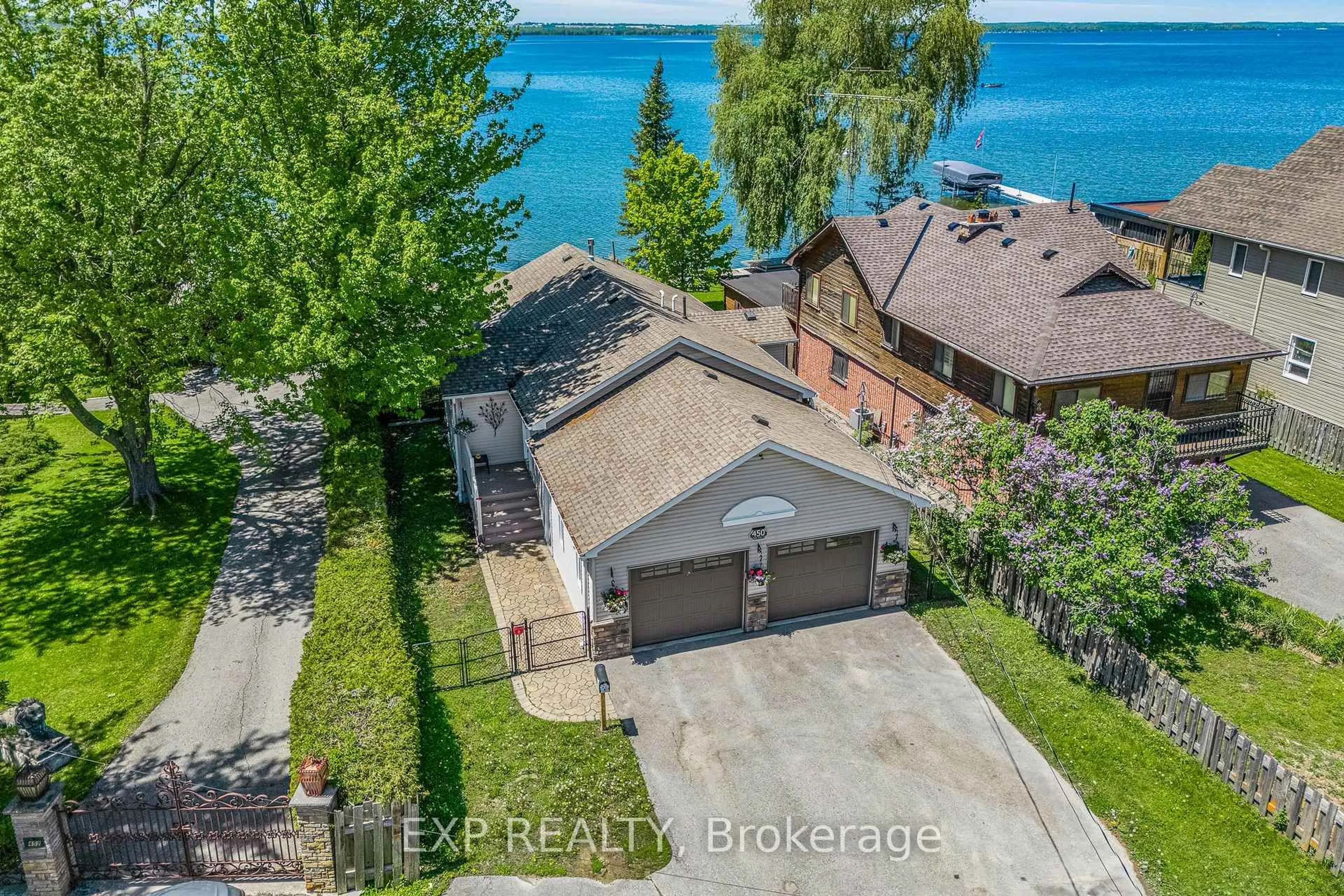 A pic from outside/outdoor area/front of a property/back of a property/a pic from drone, water/lake/river/ocean view for 450 Lake Dr, Georgina Ontario L4P 1P9