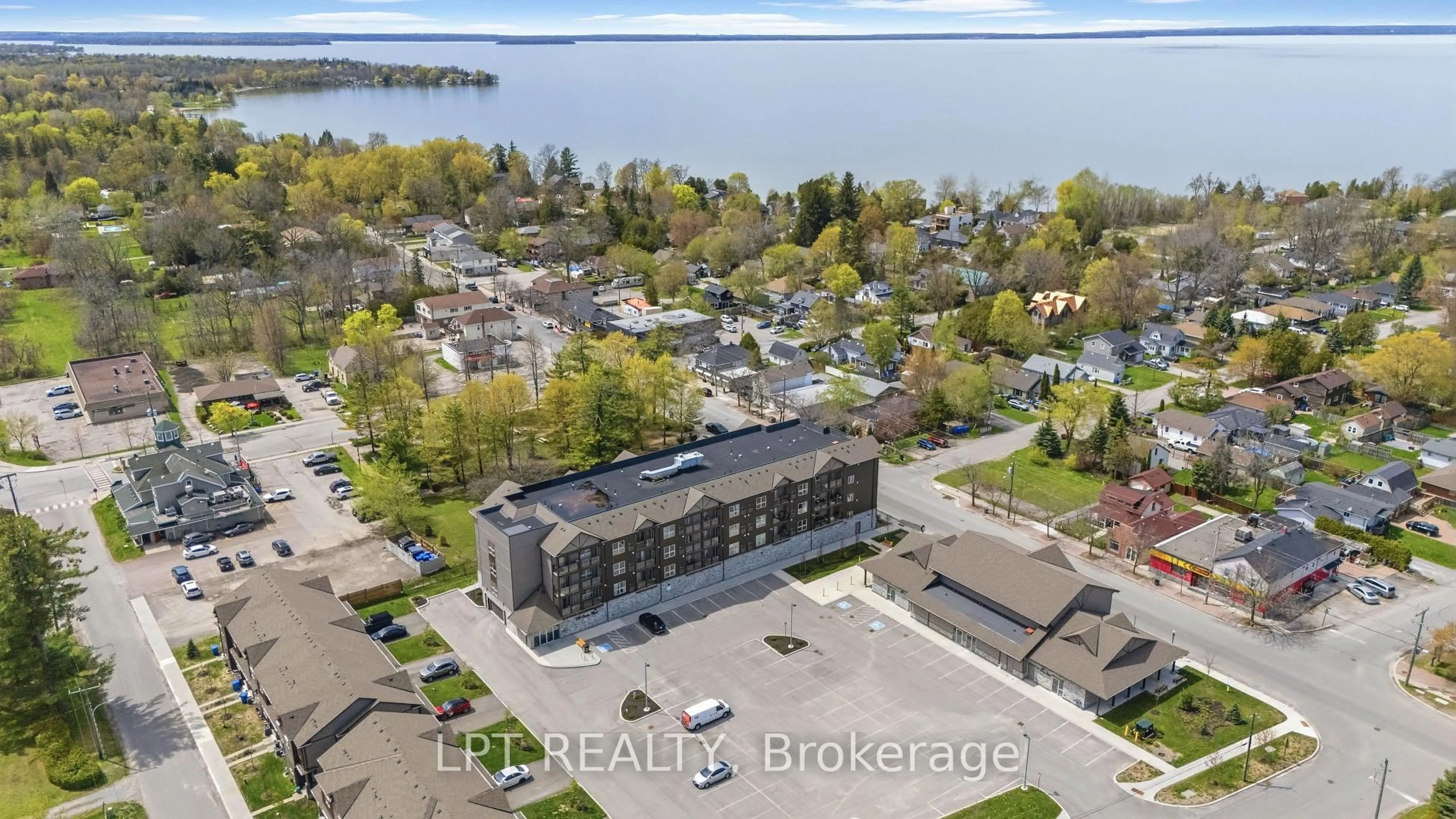 A pic from outside/outdoor area/front of a property/back of a property/a pic from drone, water/lake/river/ocean view for 110 Grew Blvd #303, Georgina Ontario L0E 1L0