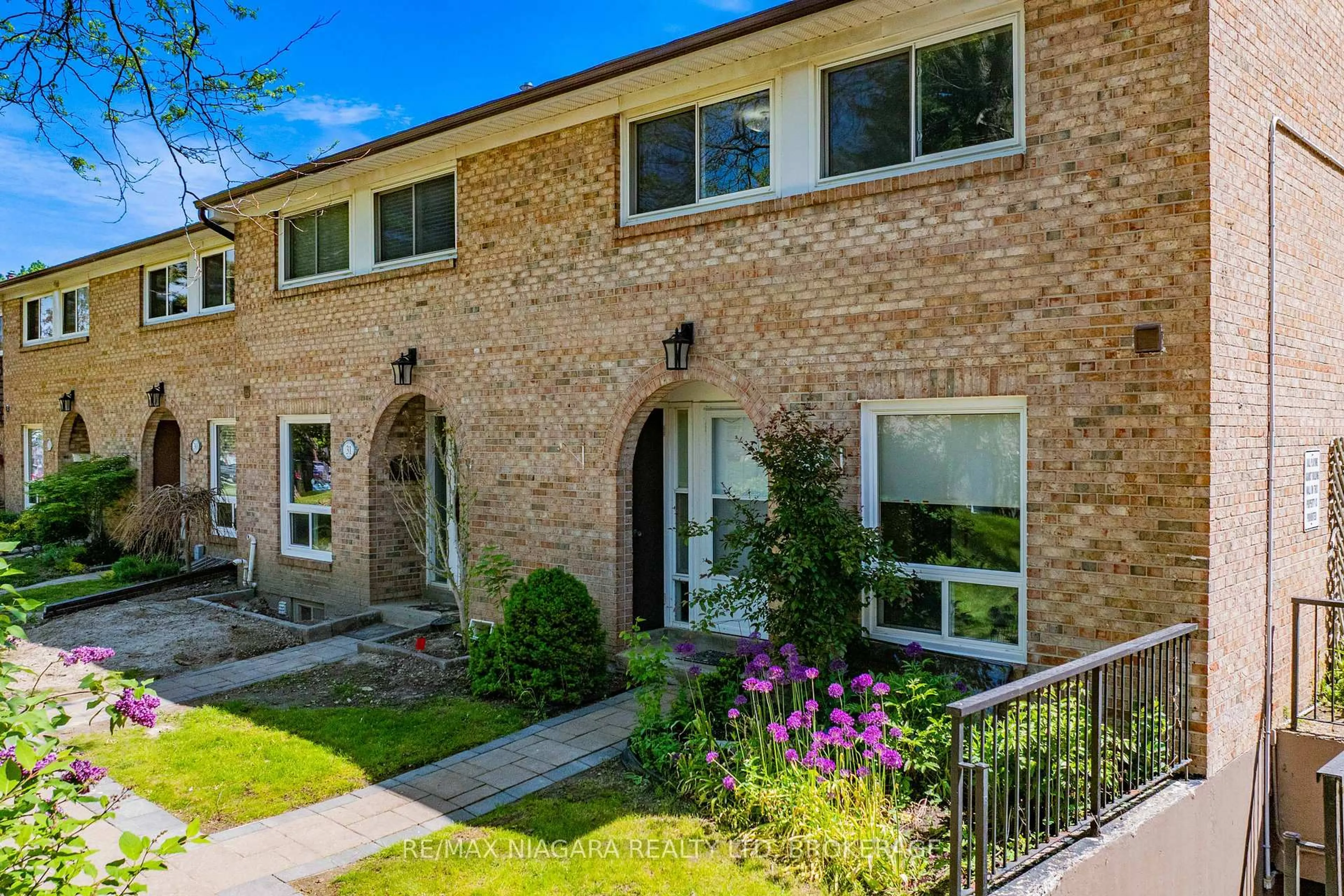 Home with brick exterior material, street for 1 Wootten Way #32, Markham Ontario L3P 3H7