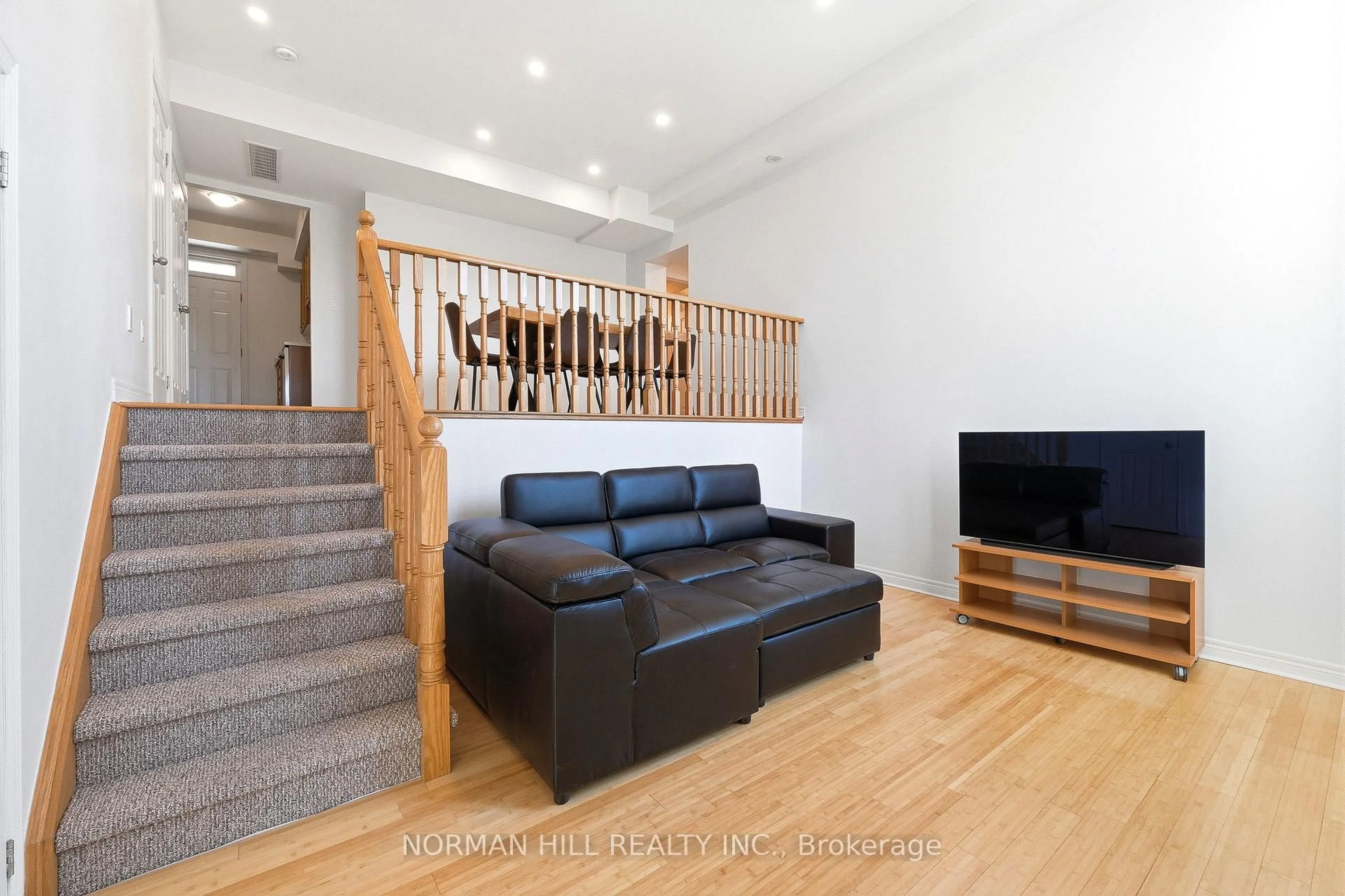 Living room with furniture, wood/laminate floor for 42 Comely Way, Markham Ontario L3R 2L8