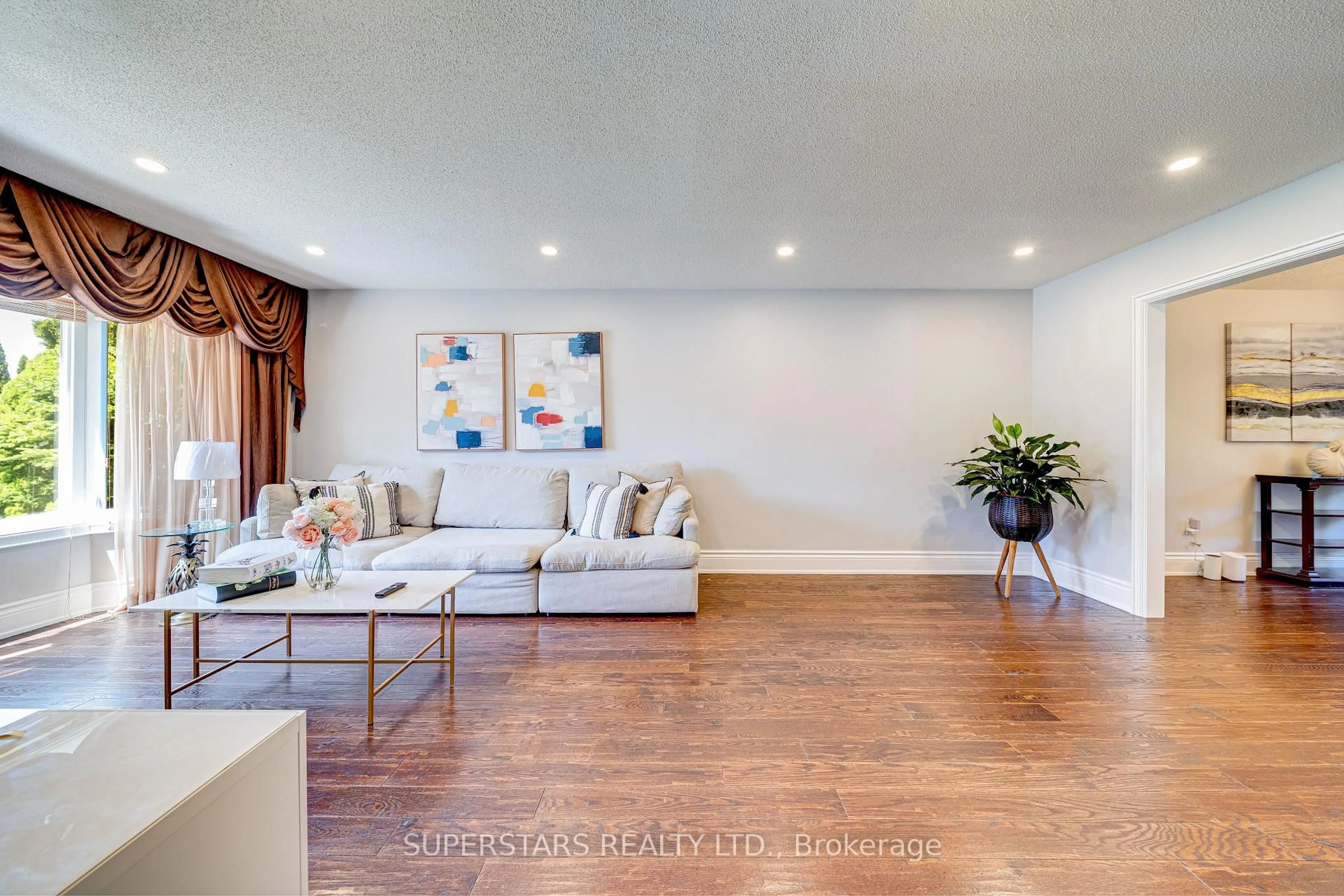Living room with furniture, wood/laminate floor for 22 West Side Dr, Markham Ontario L3P 7J4