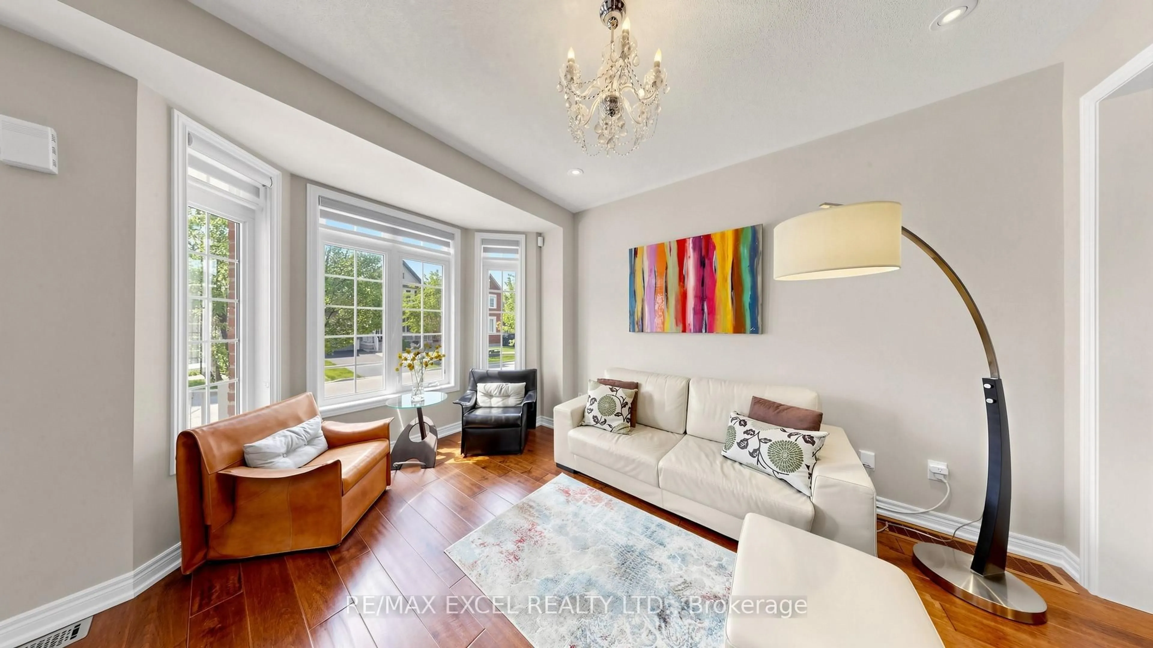 Living room with furniture, wood/laminate floor for 14 James Joyce Dr, Markham Ontario L6C 0L6