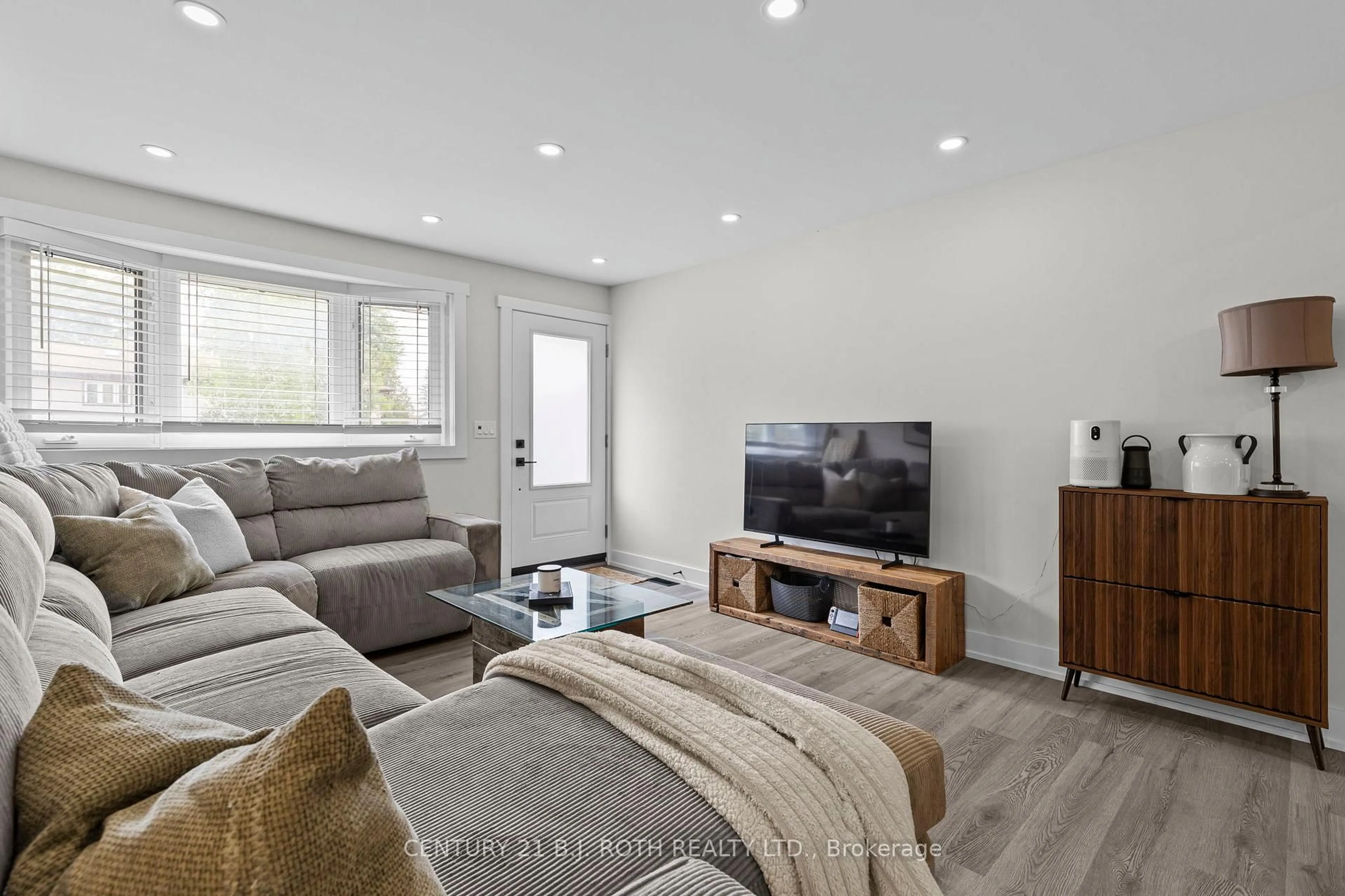 Living room with furniture, wood/laminate floor for 106 Malcolm St, Essa Ontario L0M 1B0