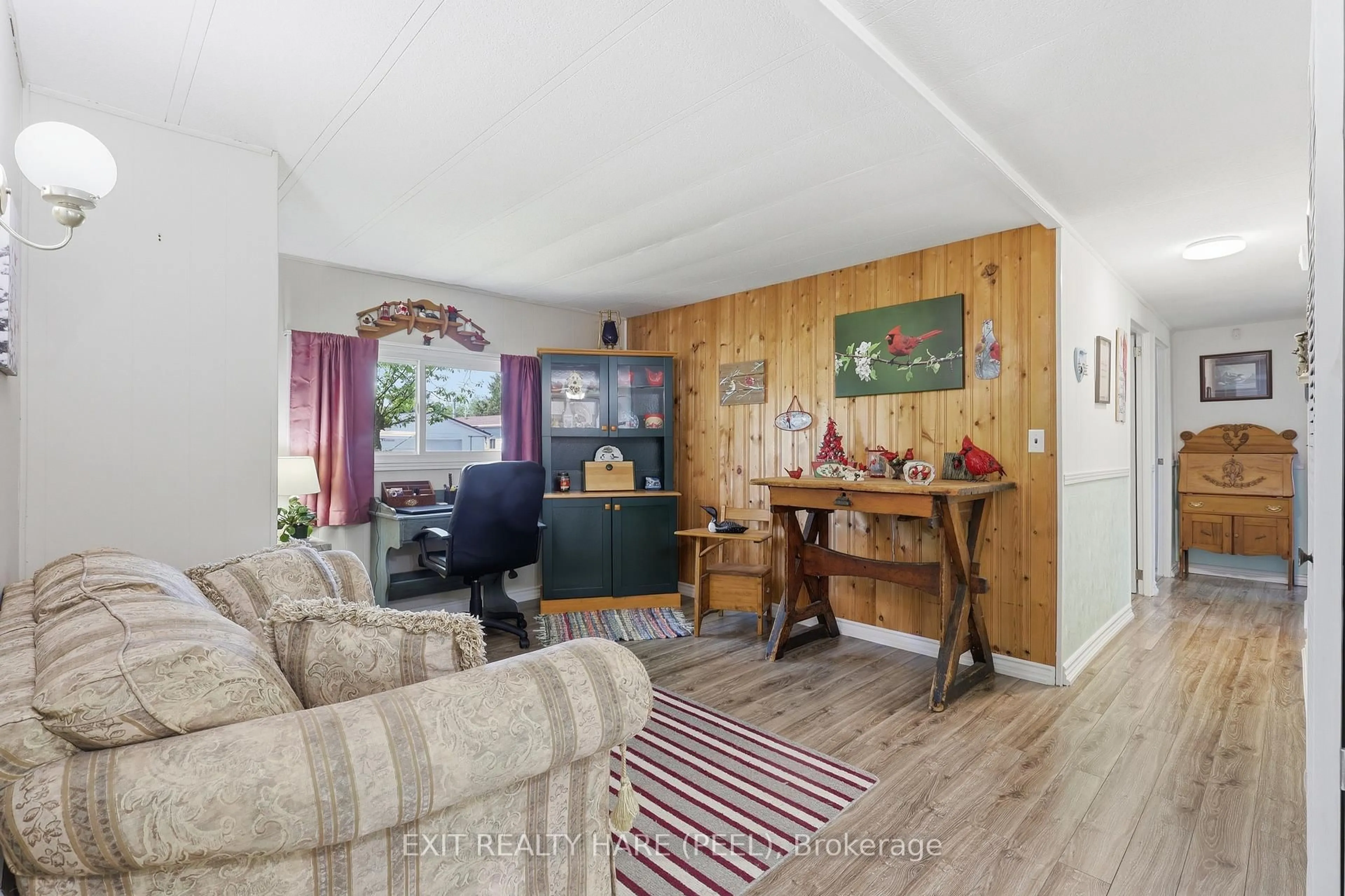 Living room with furniture, wood/laminate floor for 1 Centre Park St, Essa Ontario L3W 0A5