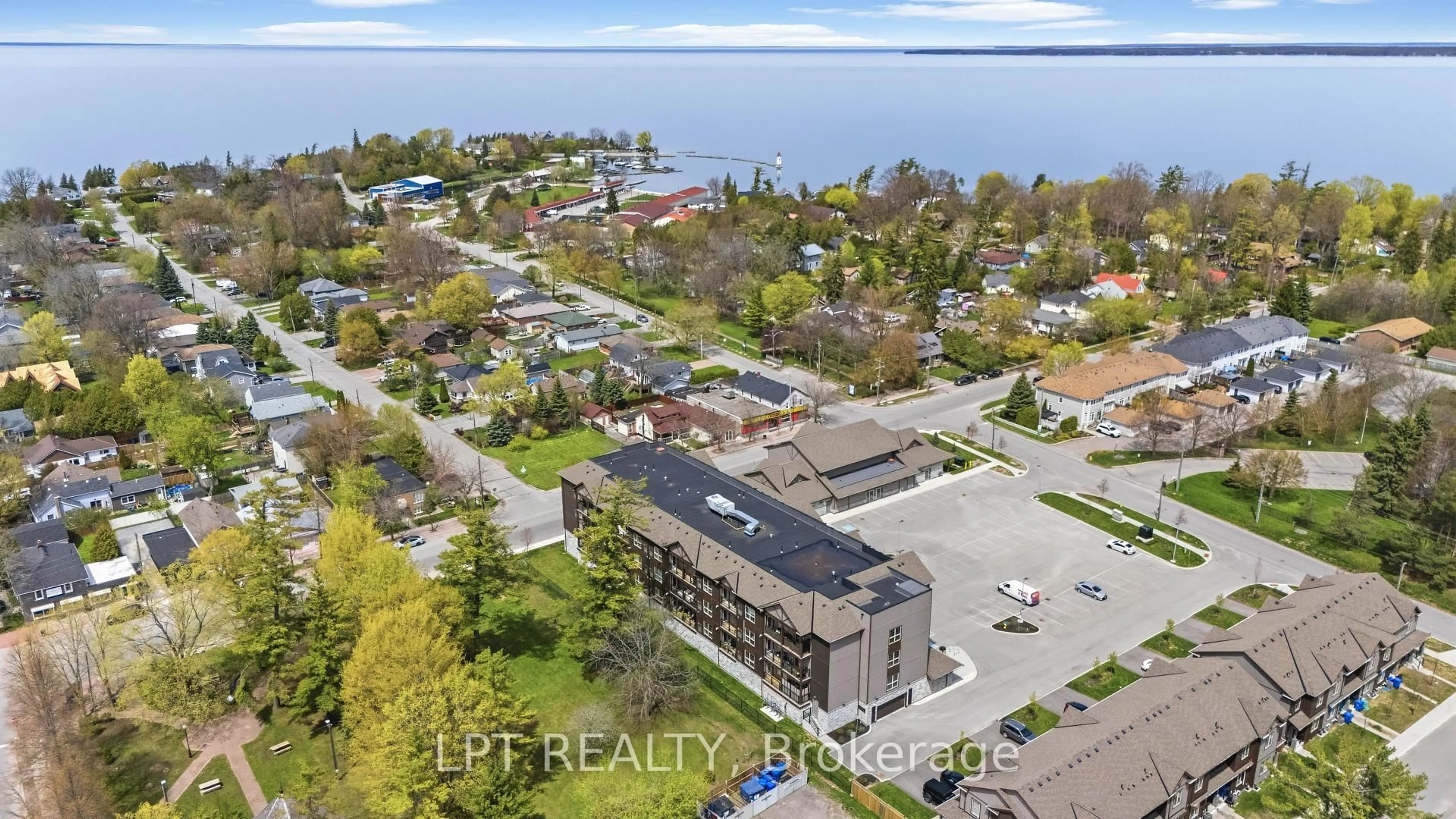 A pic from outside/outdoor area/front of a property/back of a property/a pic from drone, water/lake/river/ocean view for 110 Grew Blvd #303, Georgina Ontario L0E 1L0