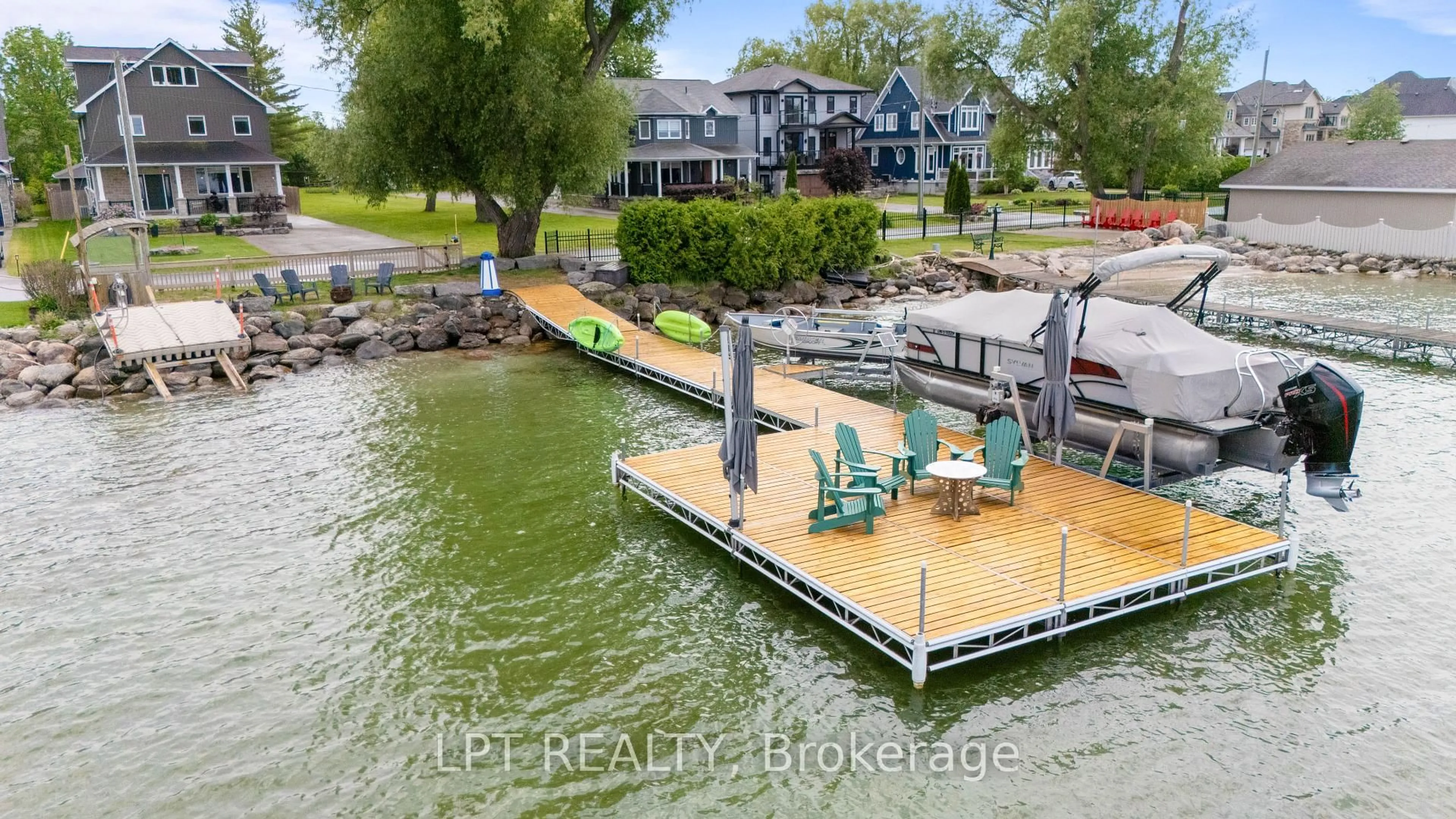 A pic from outside/outdoor area/front of a property/back of a property/a pic from drone, water/lake/river/ocean view for 165 Lake Dr, Georgina Ontario L4P 3E9