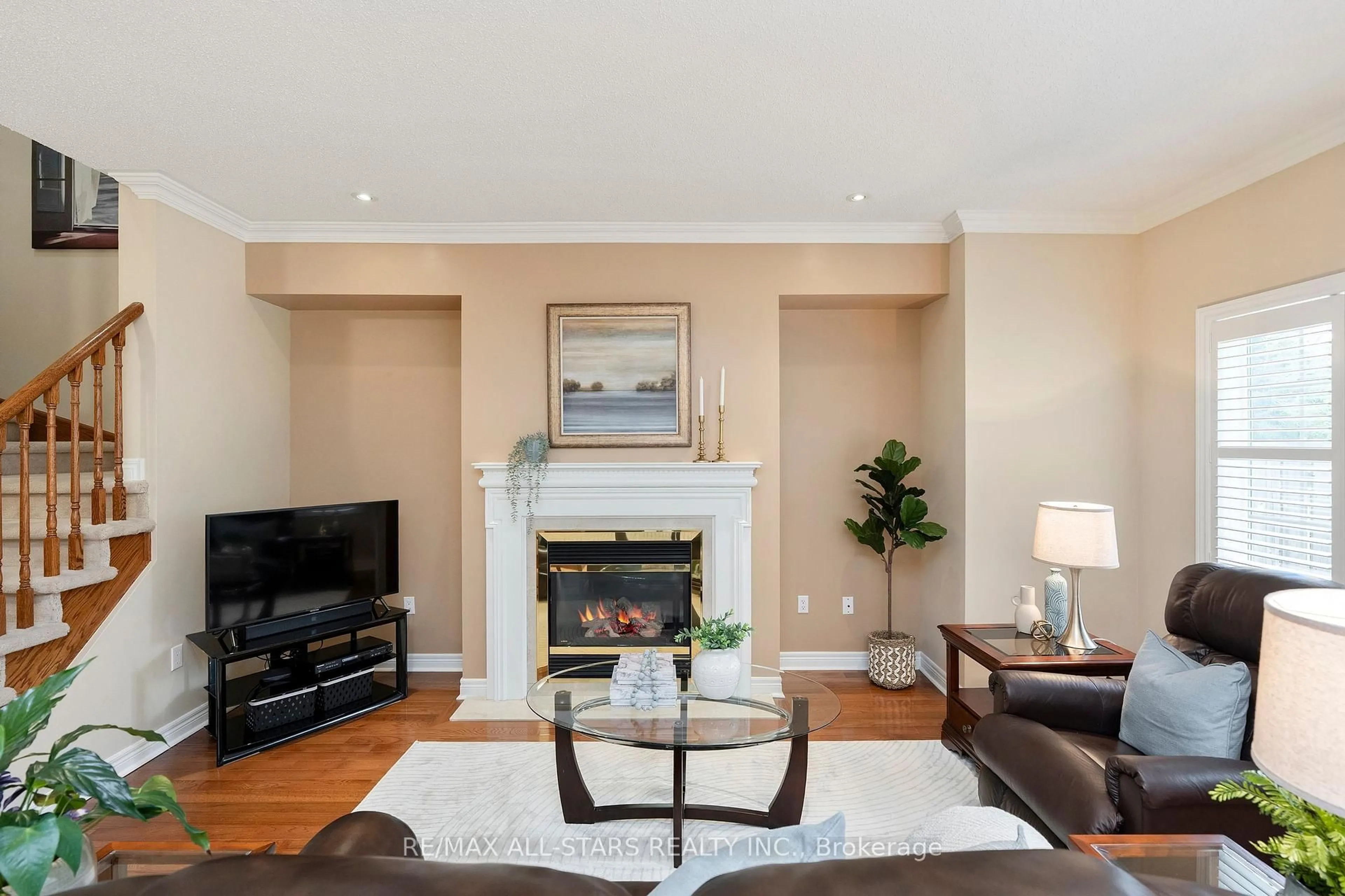 Living room with furniture, wood/laminate floor for 27 Wave Hill Way, Markham Ontario L6E 2A2