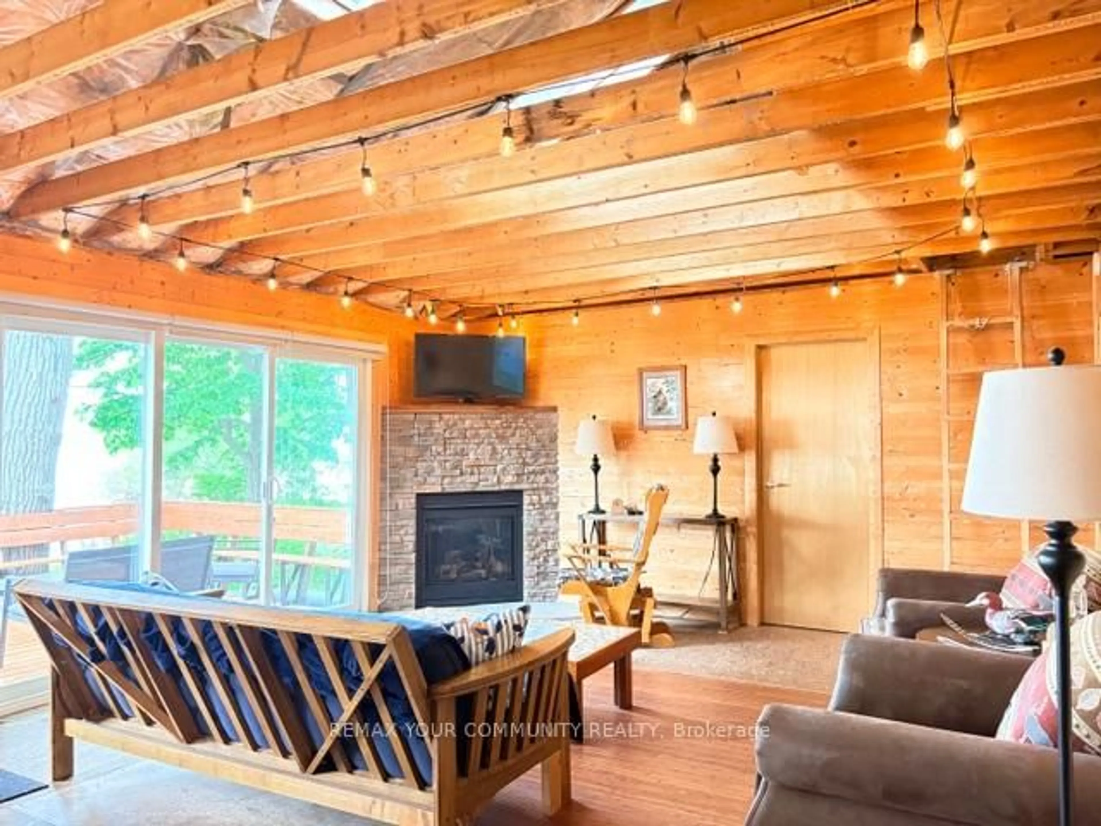 Living room with furniture, wood/laminate floor for 58 Snake Island Rd, Georgina Islands Ontario L4P 3E9