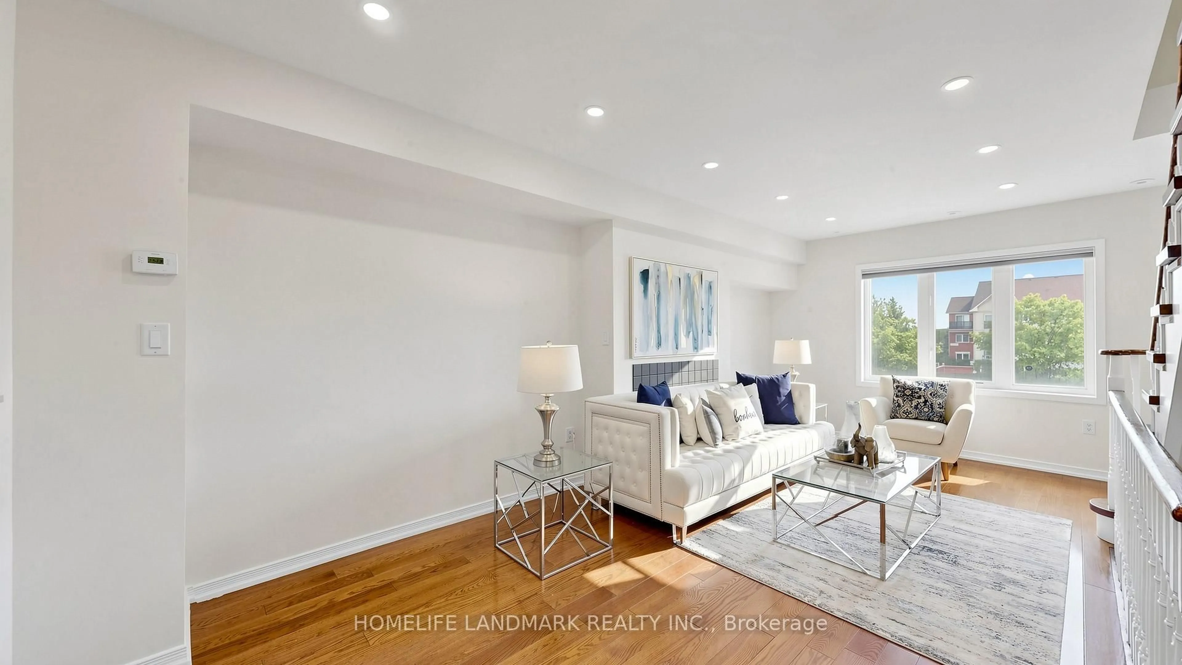 Living room with furniture, wood/laminate floor for 70 Sanctuary Way, Markham Ontario L6E 0C2