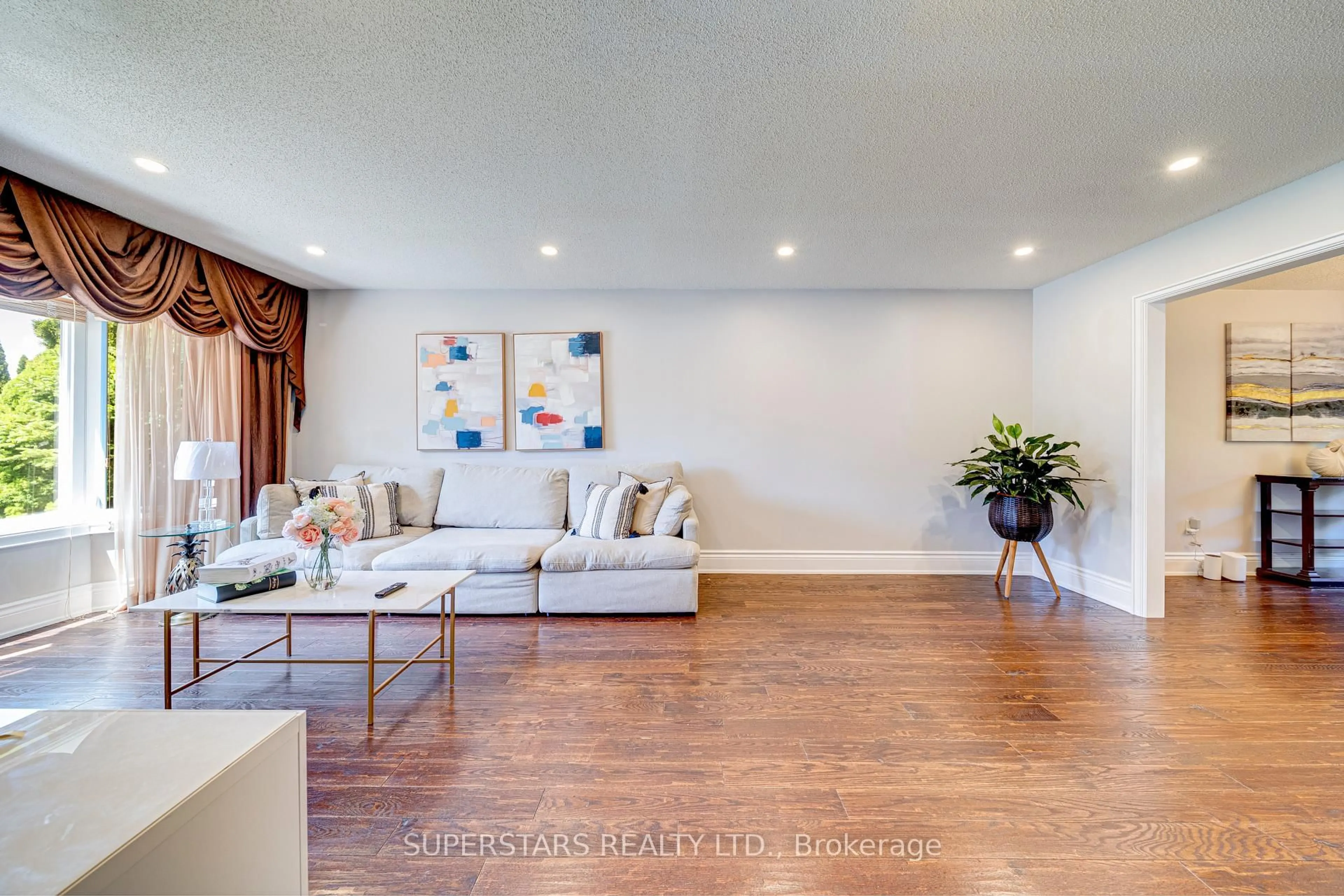 Living room with furniture, wood/laminate floor for 22 West Side Dr, Markham Ontario L3P 7J4