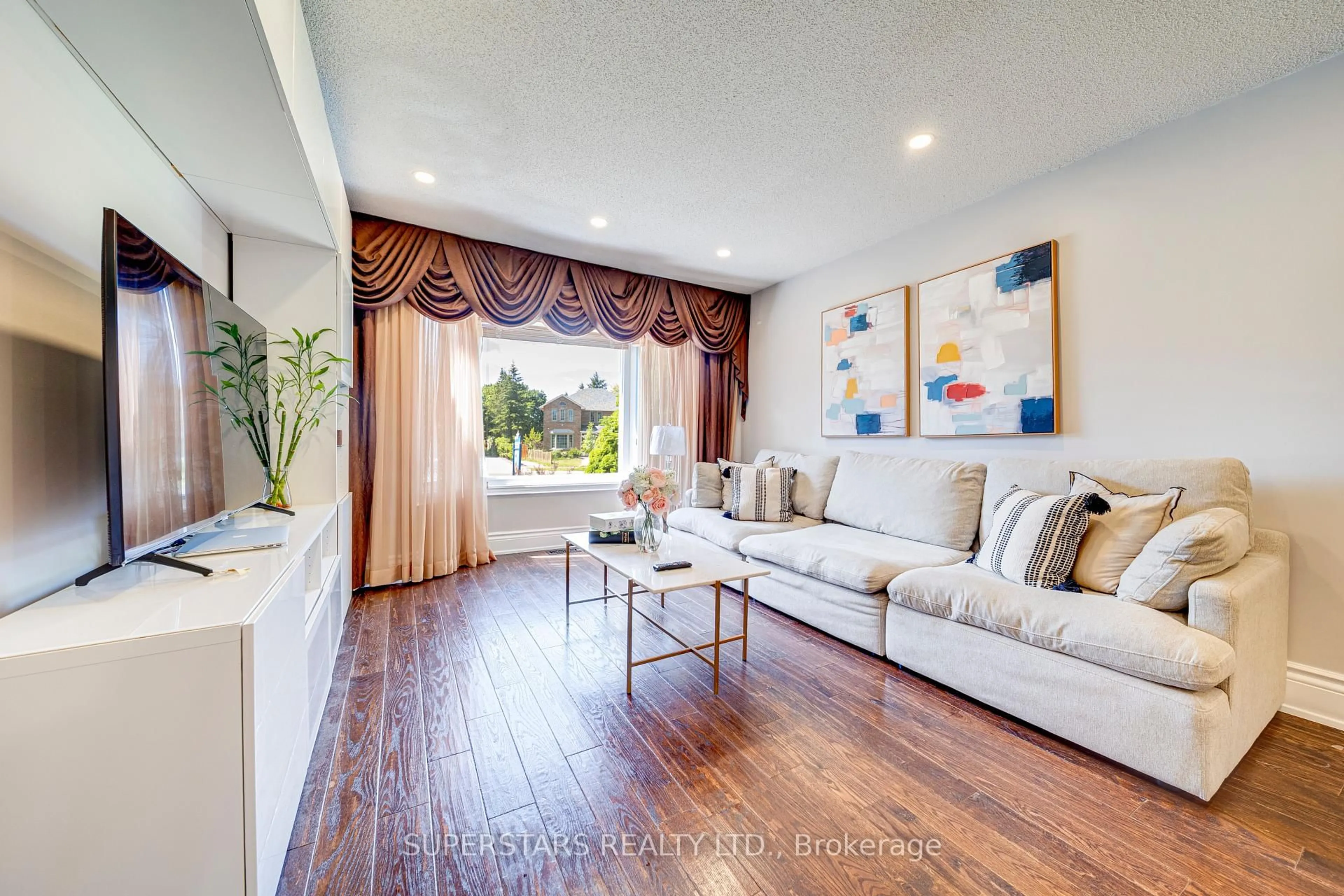 Living room with furniture, wood/laminate floor for 22 West Side Dr, Markham Ontario L3P 7J4