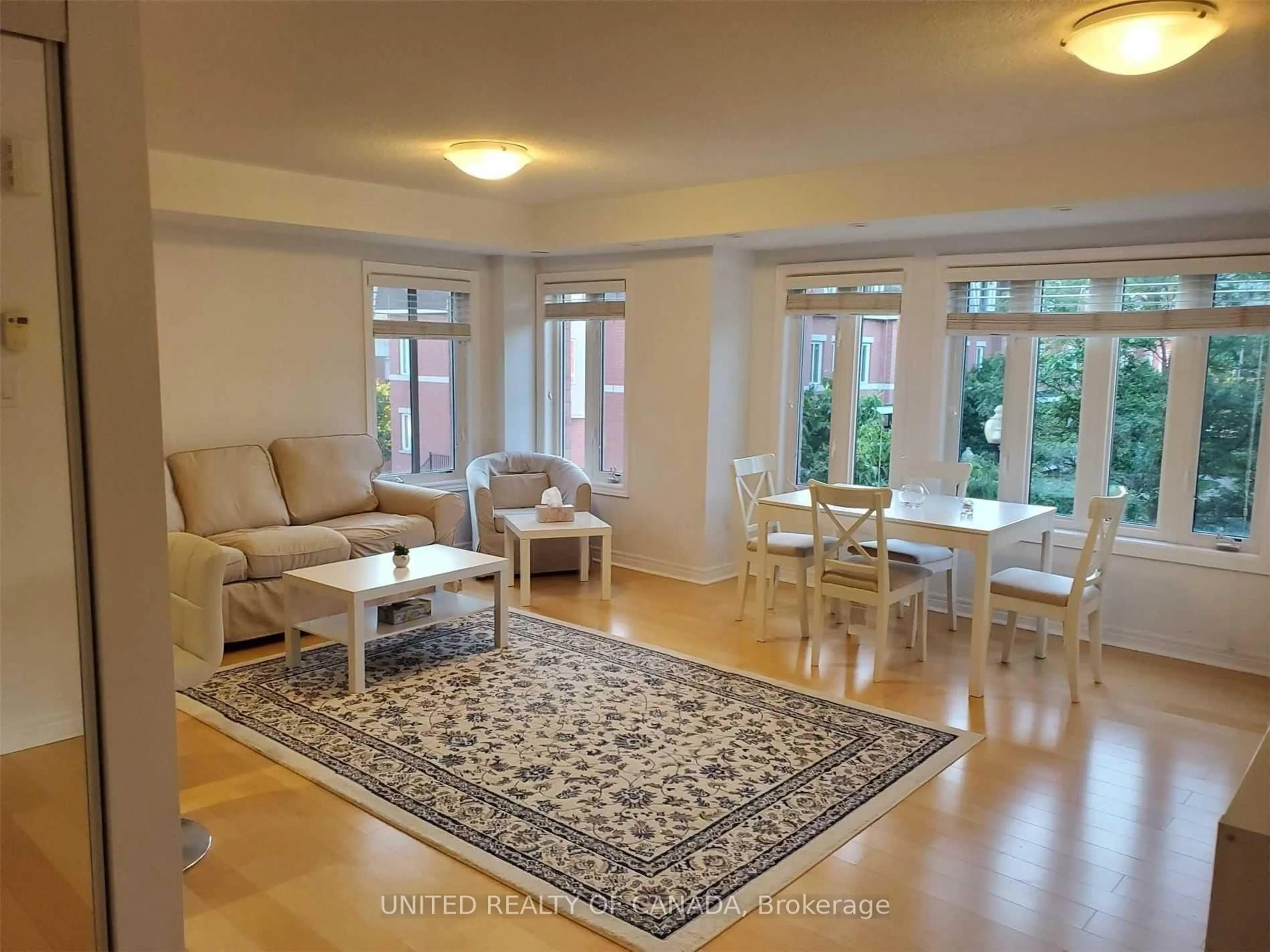 Living room with furniture, wood/laminate floor for 312 John St #330, Markham Ontario L3T 0A7