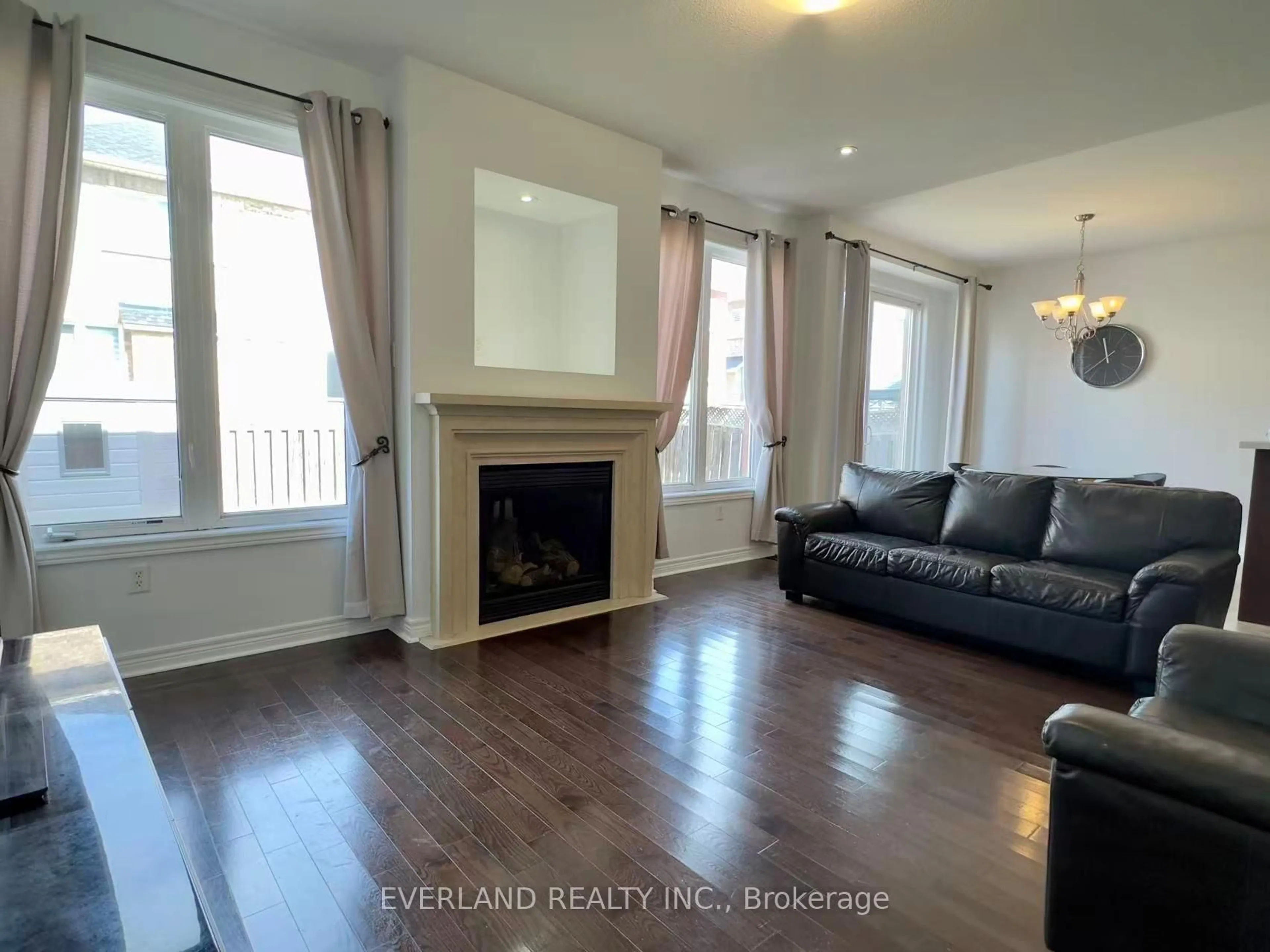 Living room with furniture, wood/laminate floor for 22 Lundy Dr, Markham Ontario L6B 0G1