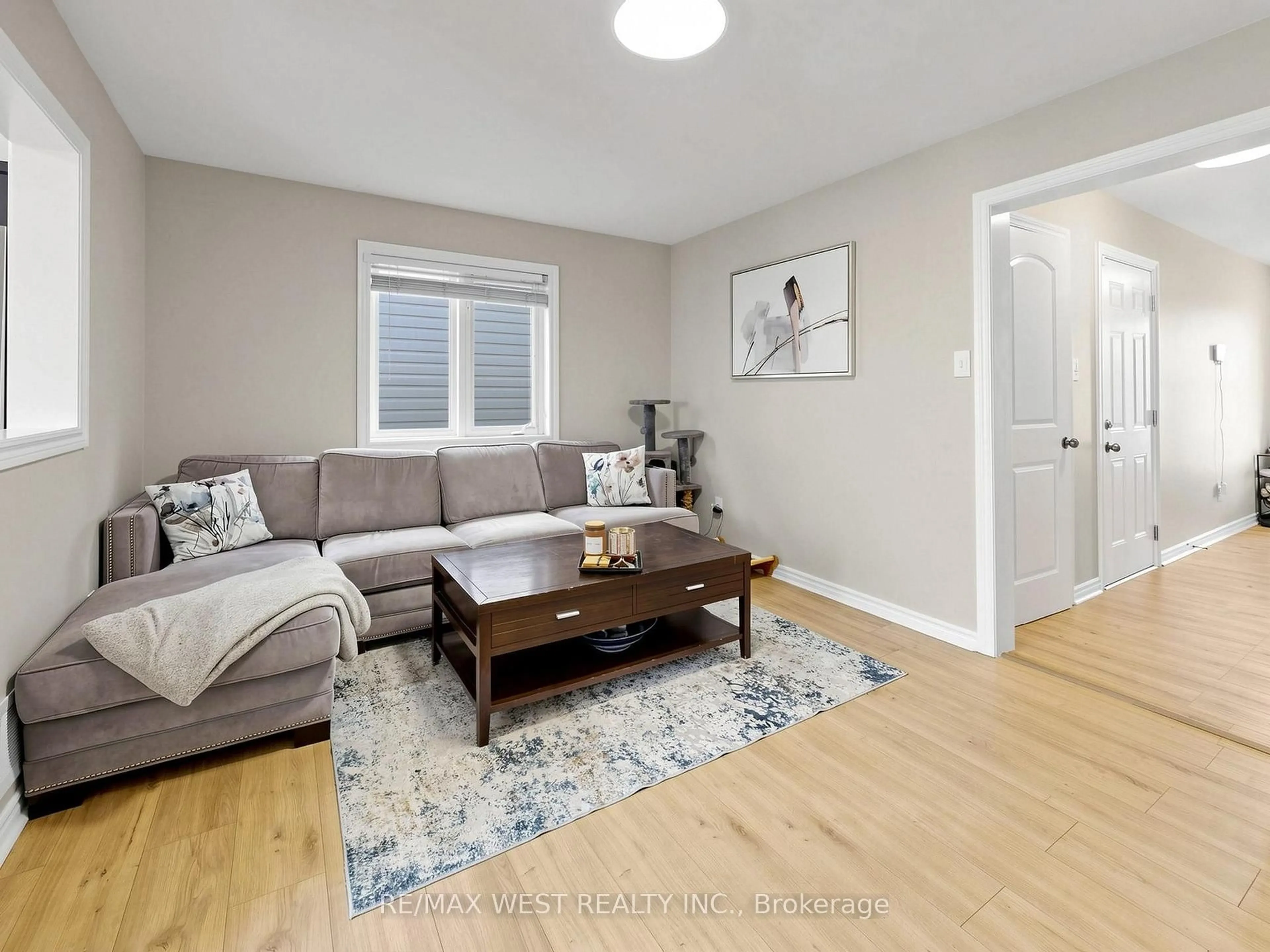 Living room with furniture, wood/laminate floor for 195 Banting Cres, Essa Ontario L0M 1B6