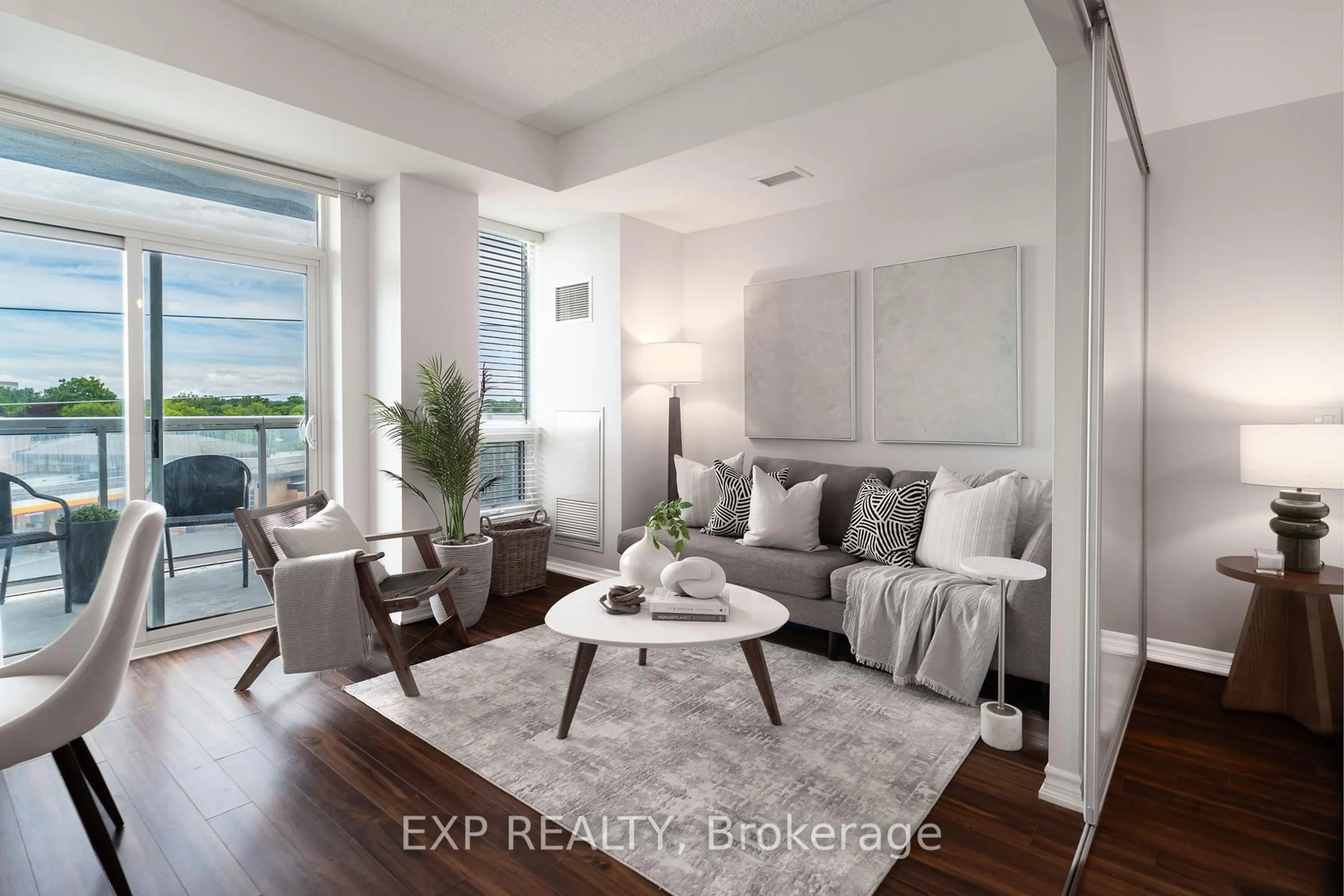 Living room with furniture, wood/laminate floor for 8323 Kennedy Rd #323, Markham Ontario L3R 5W7