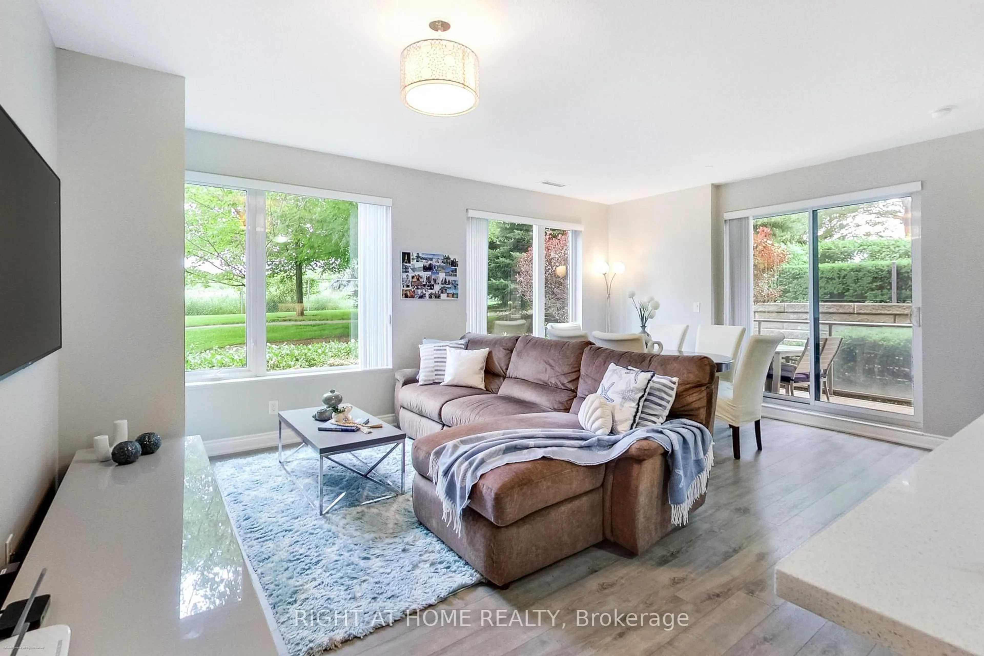Living room with furniture, wood/laminate floor for 277 South Park Rd #115, Markham Ontario L3T 0B7