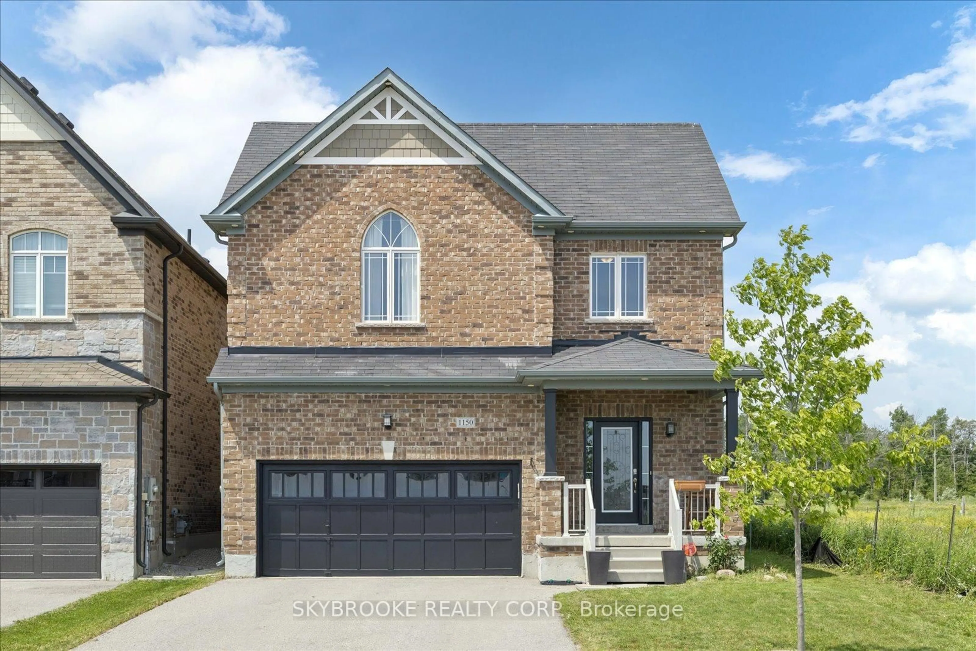 Home with brick exterior material, street for 1150 Wharram Way, Innisfil Ontario L0L 1W0