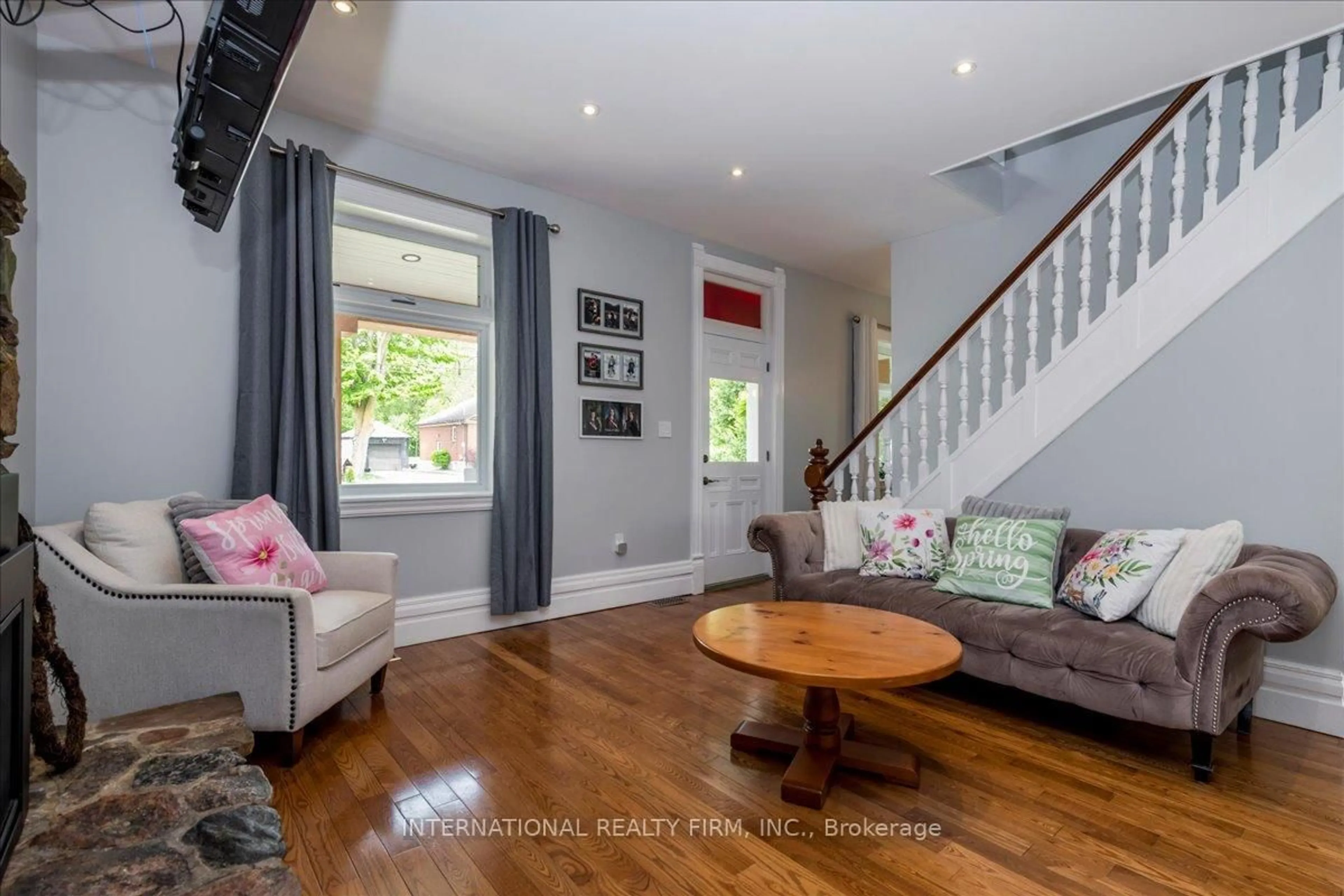 Living room with furniture, wood/laminate floor for 8061 Main St, Adjala-Tosorontio Ontario L0M 1J0