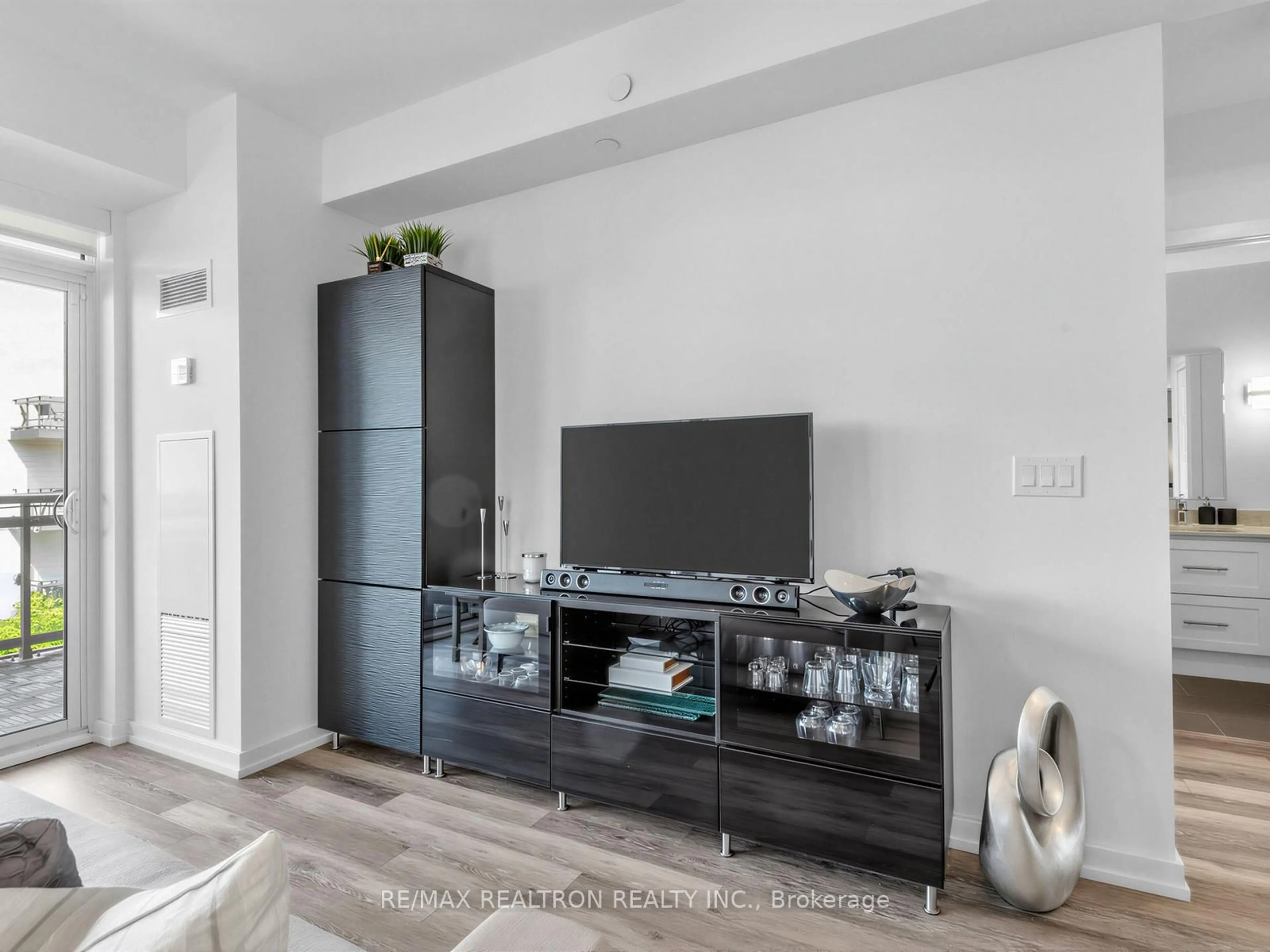 Living room with furniture, wood/laminate floor for 241 Sea Ray Ave #A311, Innisfil Ontario L9S 0L9