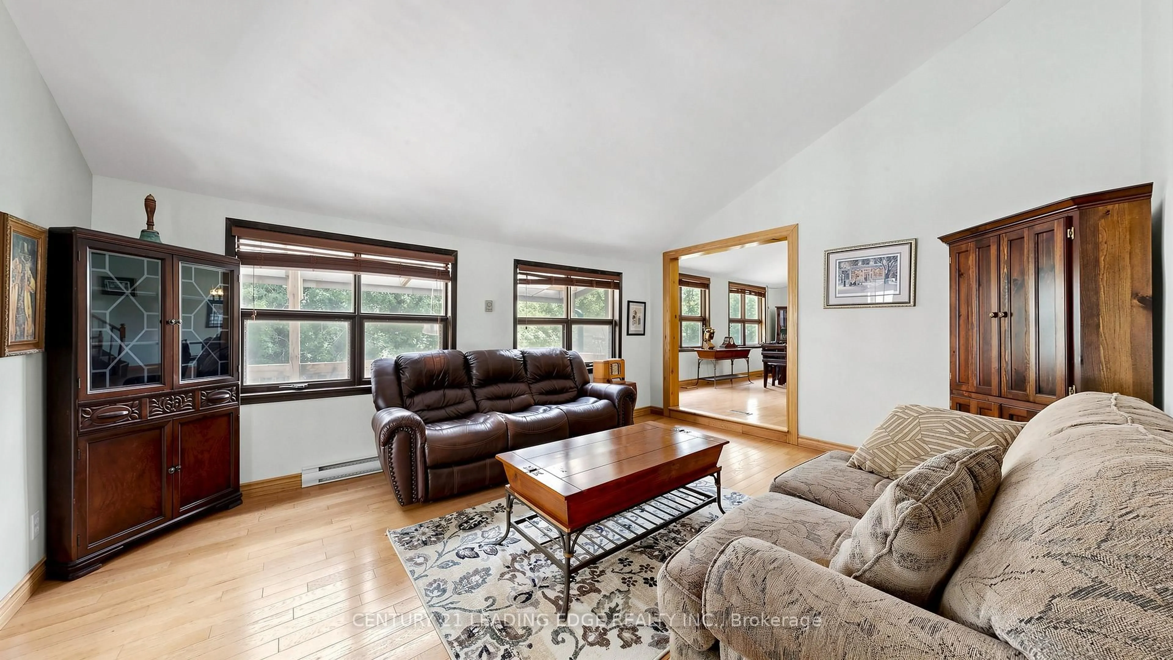 Living room with furniture, wood/laminate floor for 6466 Old Homestead Rd, Georgina Ontario L0E 1R0