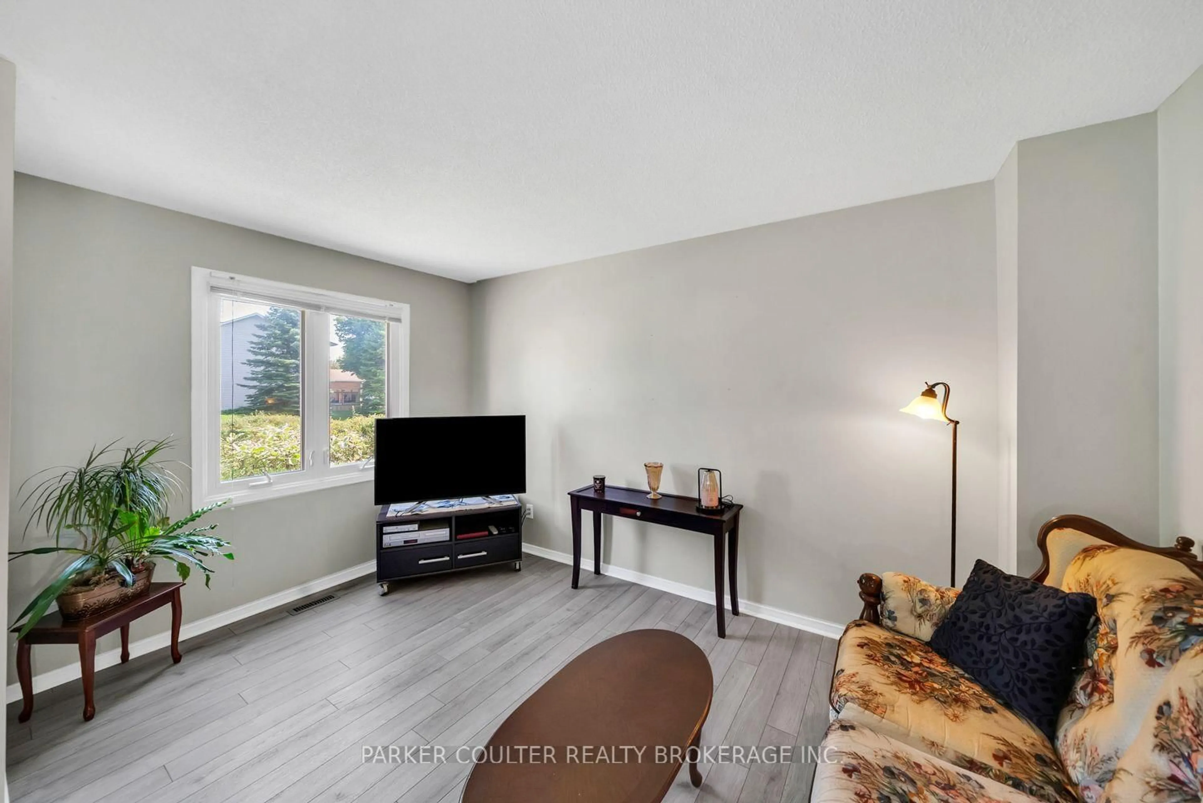 Living room with furniture, wood/laminate floor for 1098 Maclean St, Innisfil Ontario L9S 1W1