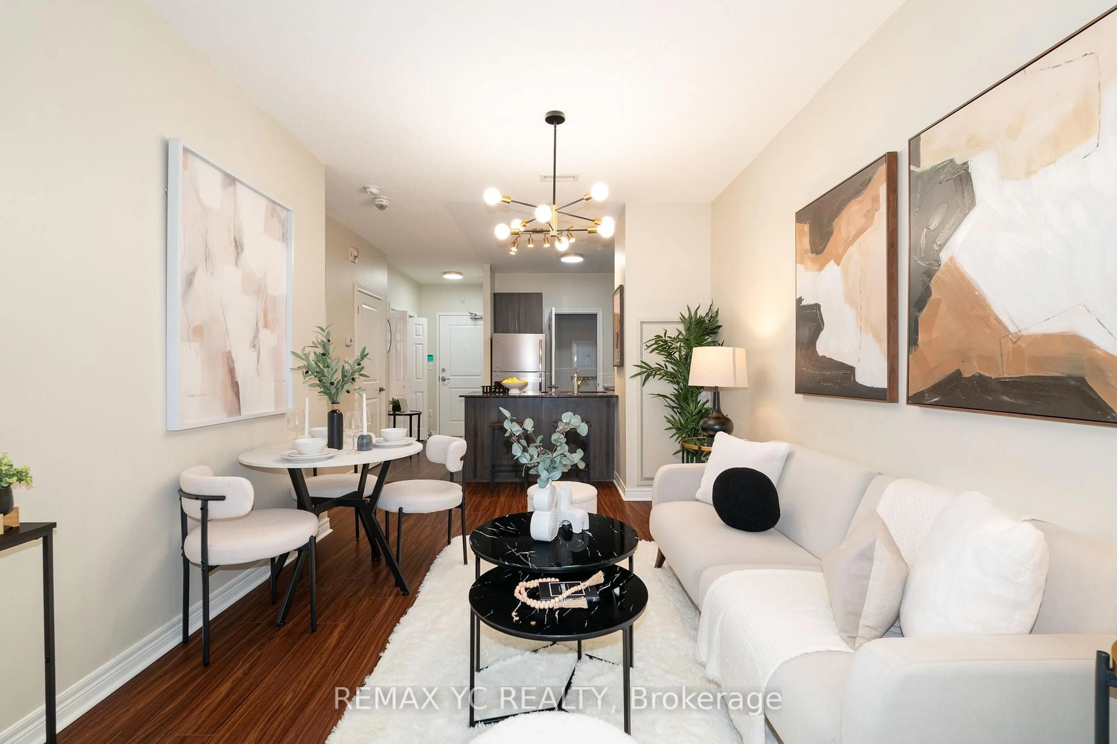 Living room with furniture, wood/laminate floor for 7768 Kennedy Rd #102, Markham Ontario L3R 5K1
