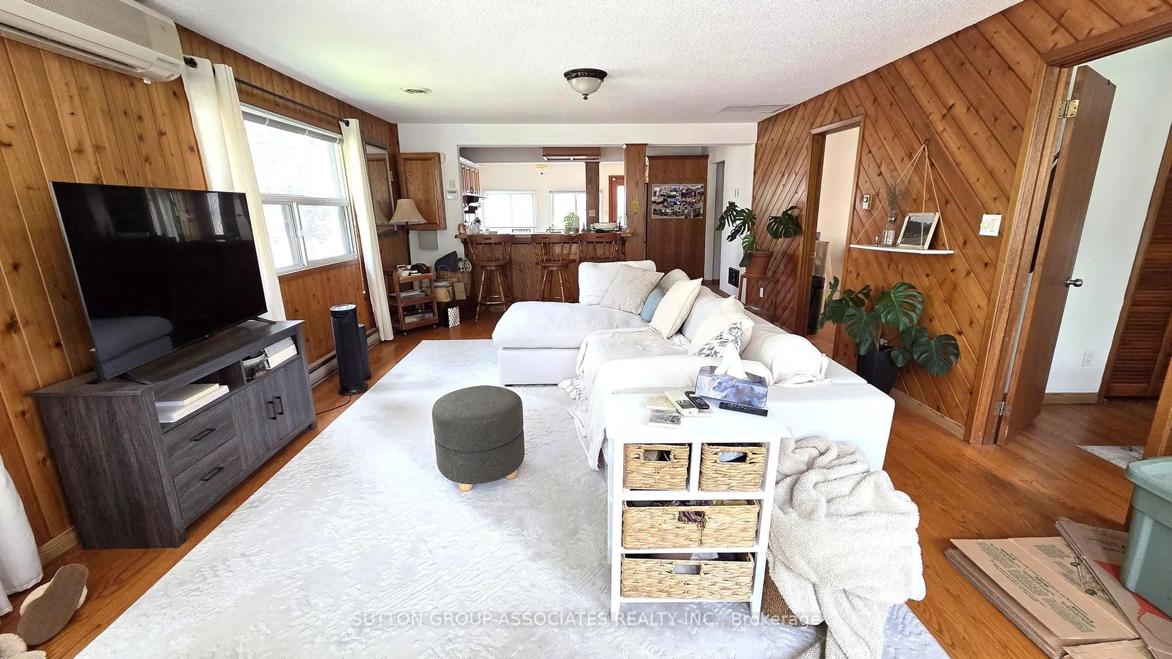 Living room with furniture, wood/laminate floor for 1099 Poplar Dr, Innisfil Ontario L0L 1R0