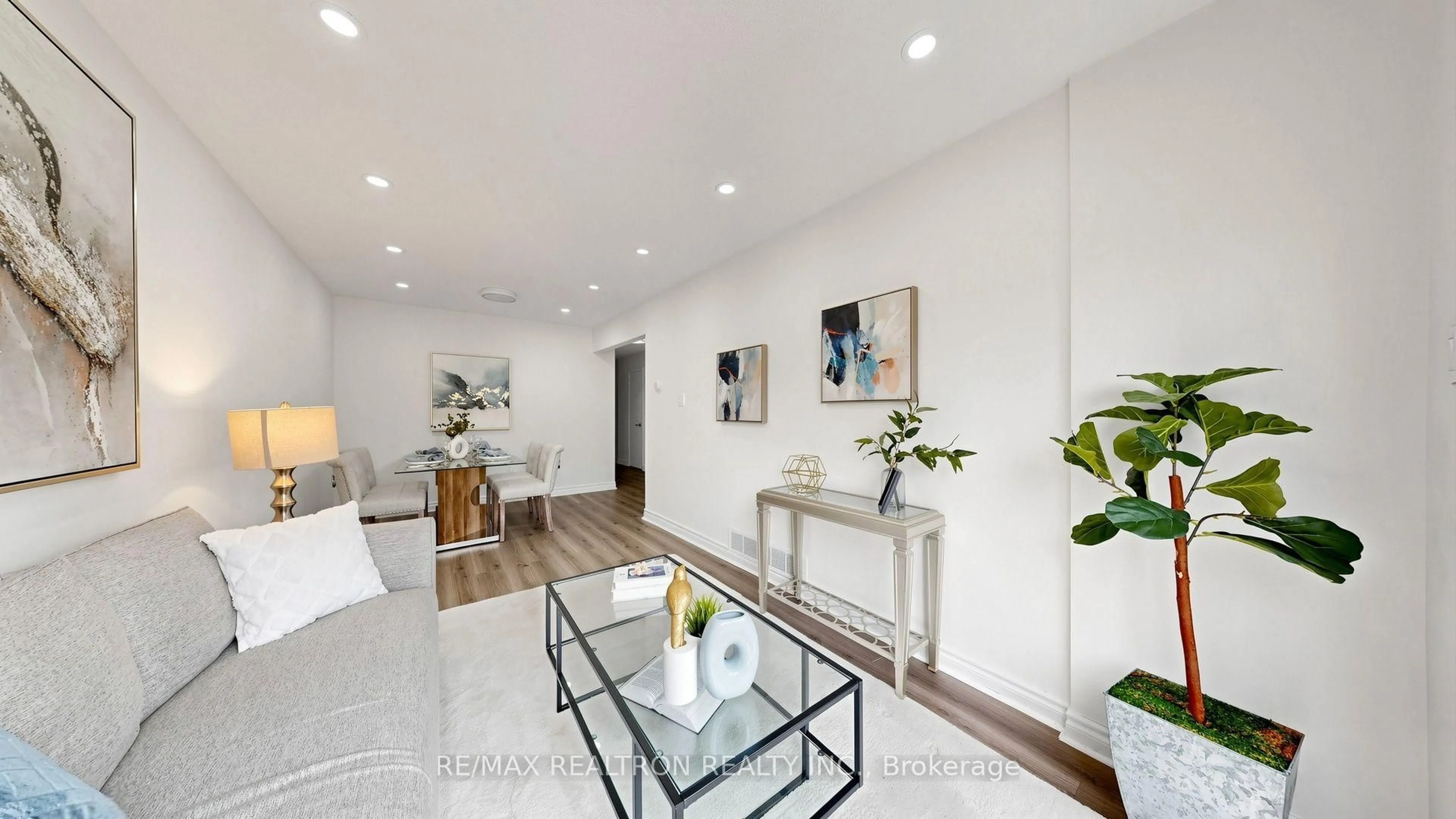 Living room with furniture, wood/laminate floor for 64 Dunbar Cres, Markham Ontario L3R 6W6