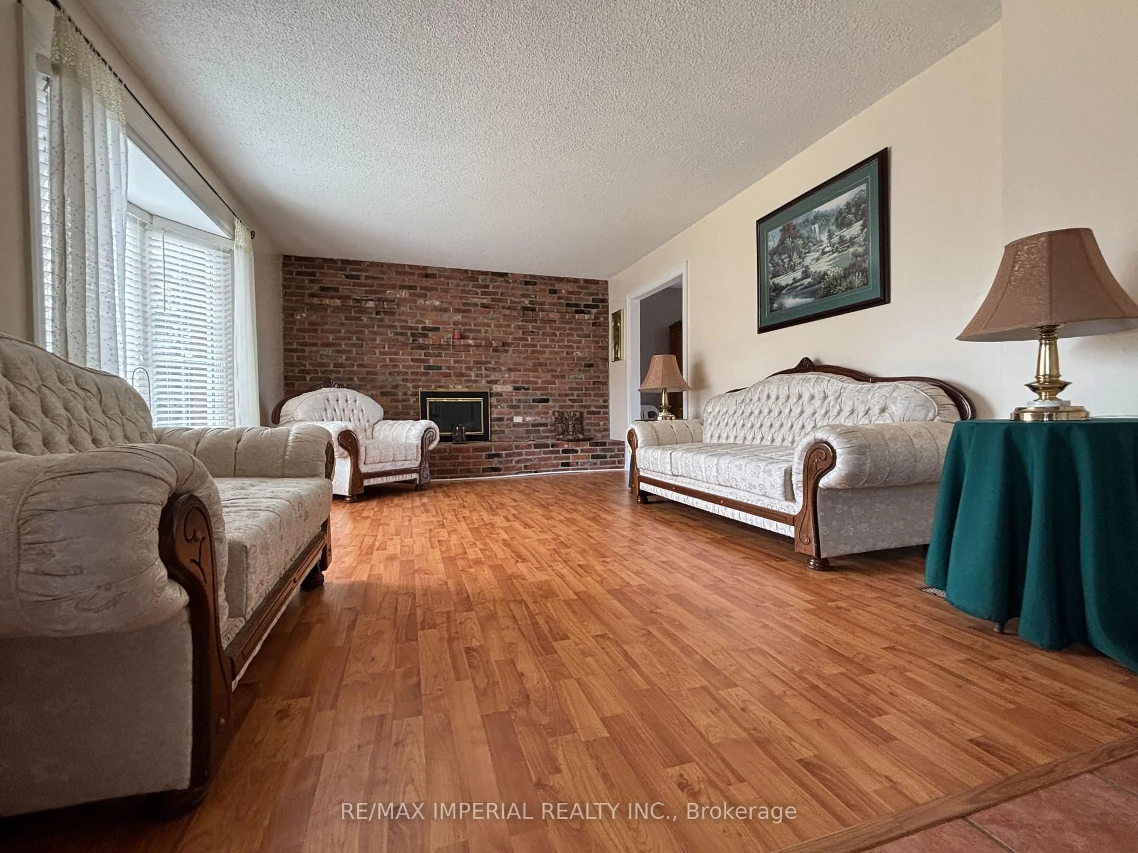 Living room with furniture, wood/laminate floor for 23276 Highway 48 Rd, Georgina Ontario L0E 1L0