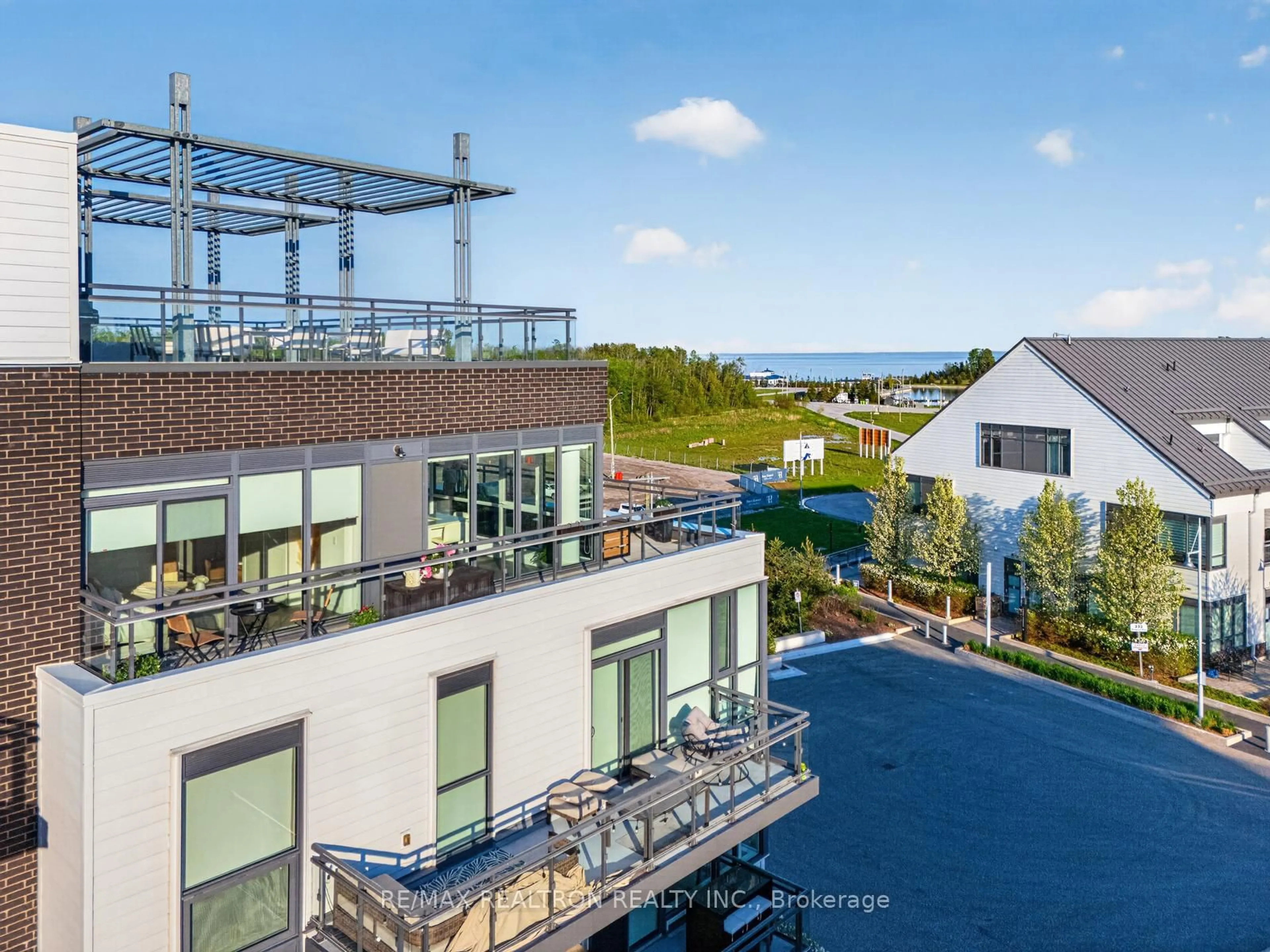 A pic from outside/outdoor area/front of a property/back of a property/a pic from drone, water/lake/river/ocean view for 241 Sea Ray Ave #A416, Innisfil Ontario L9S 0L9