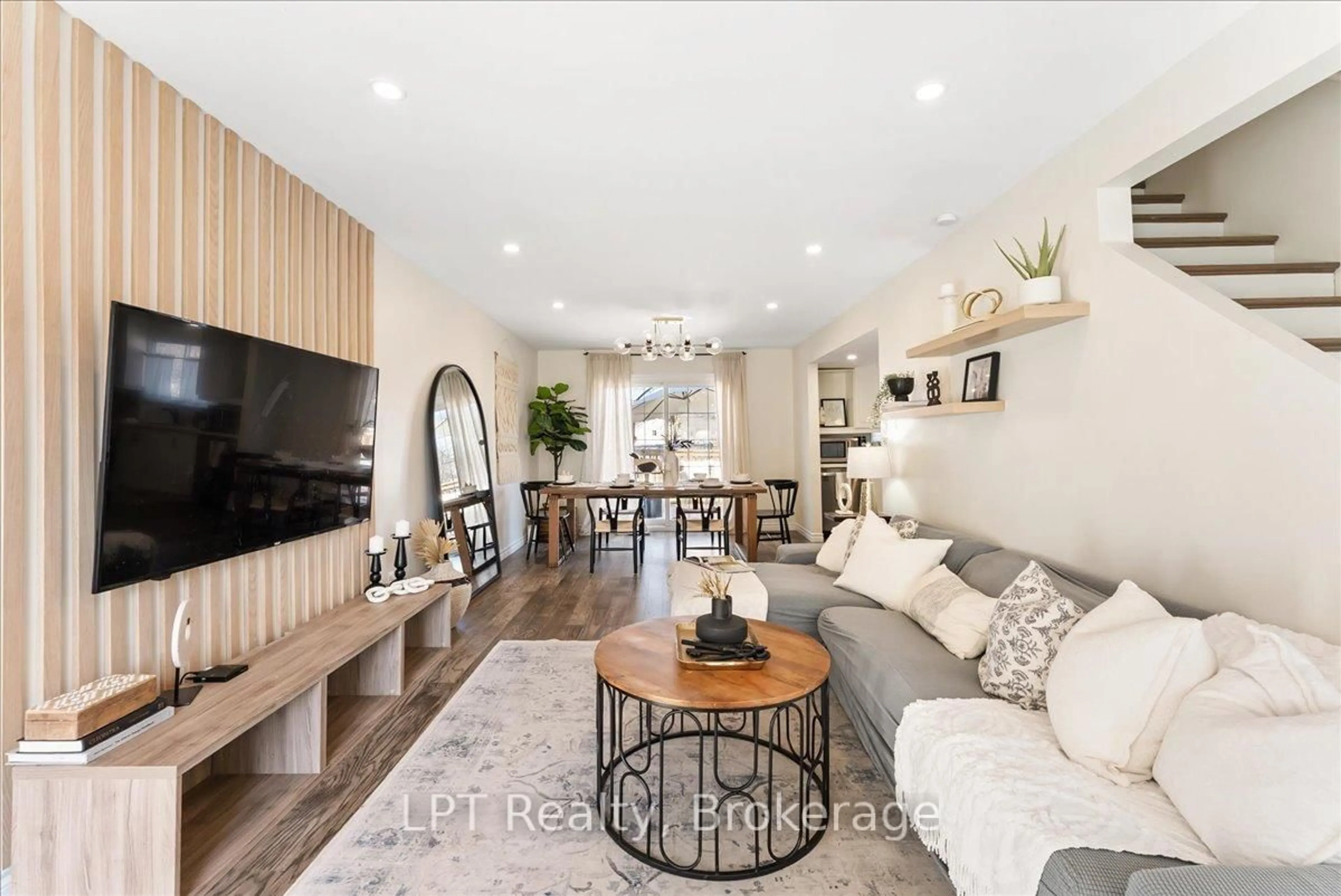 Living room with furniture, wood/laminate floor for 154 Beach Rd, Georgina Ontario L4P 2L7