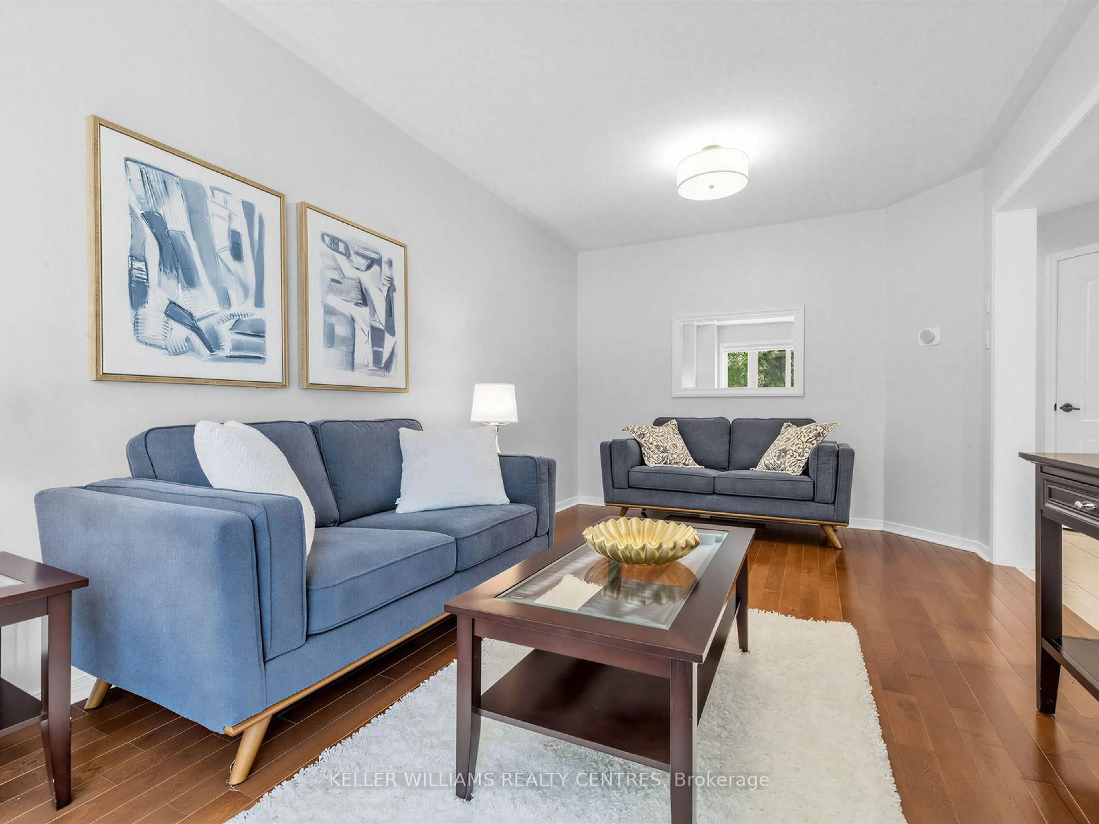 Living room with furniture, wood/laminate floor for 174 Flagstone Way, Newmarket Ontario L3X 2Z7