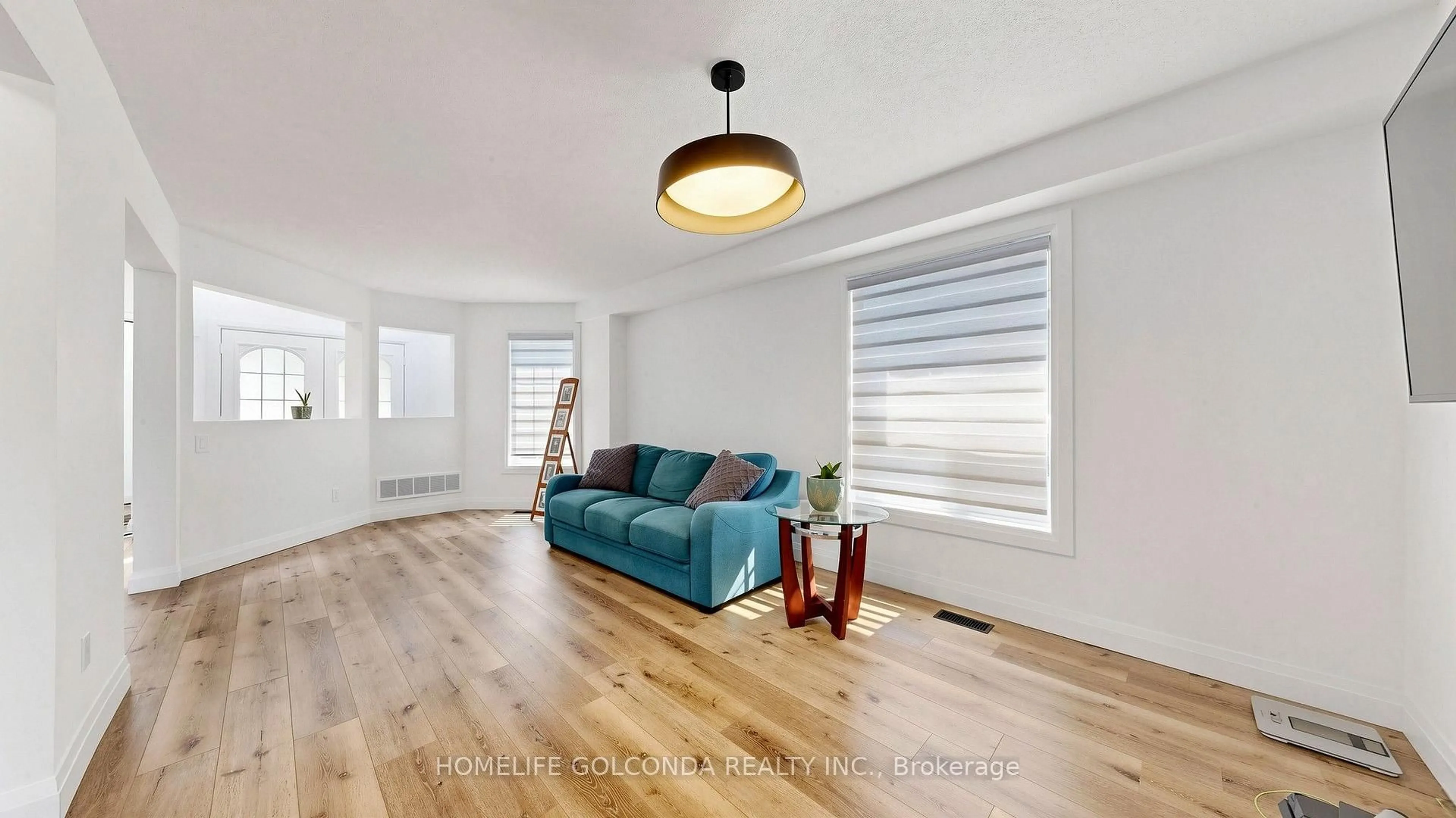 Living room with furniture, wood/laminate floor for 1304 Vincent Cres, Innisfil Ontario L9S 1Z8