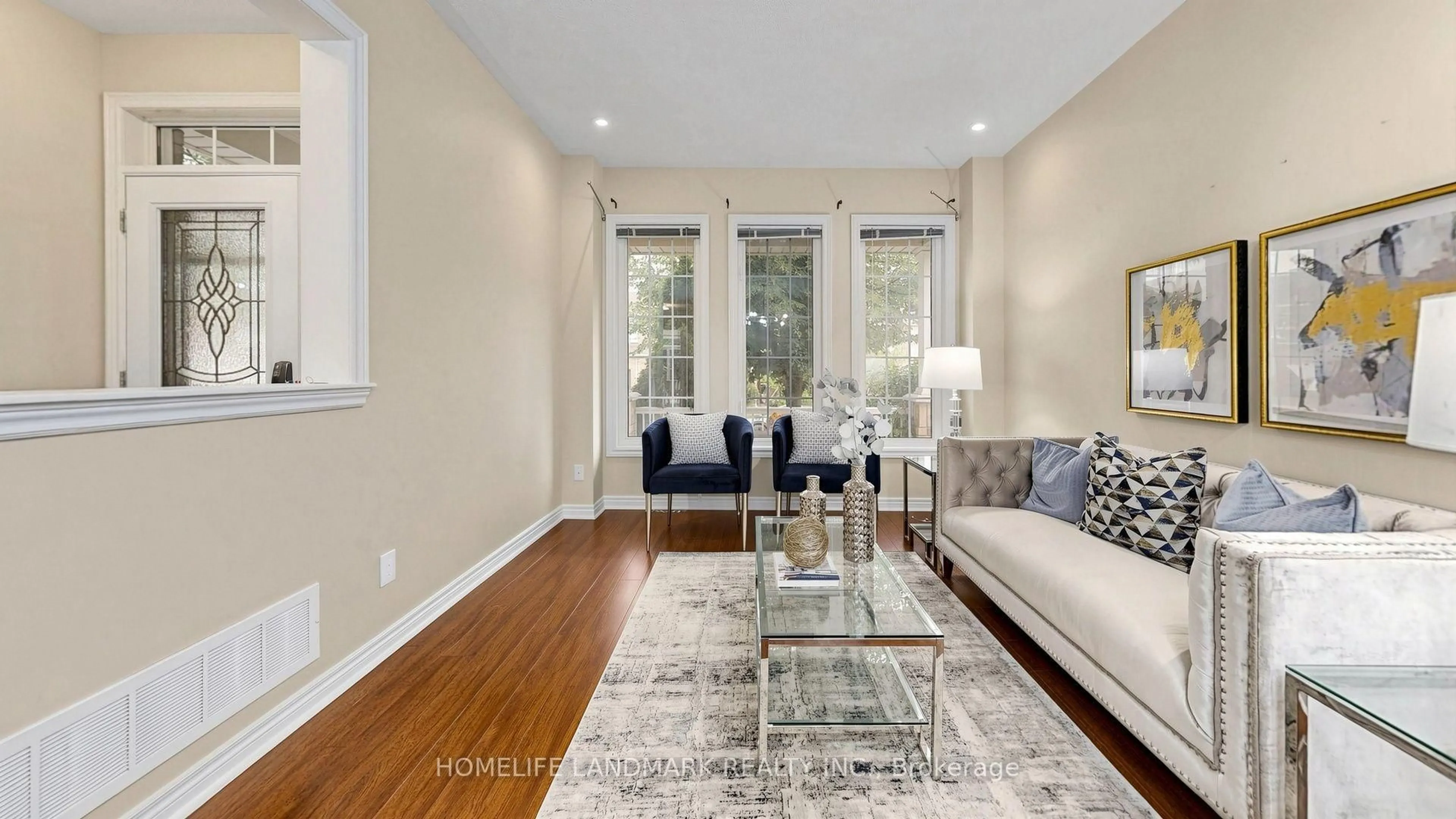 Living room with furniture, wood/laminate floor for 129 Beare Tr, Newmarket Ontario L3X 3B6