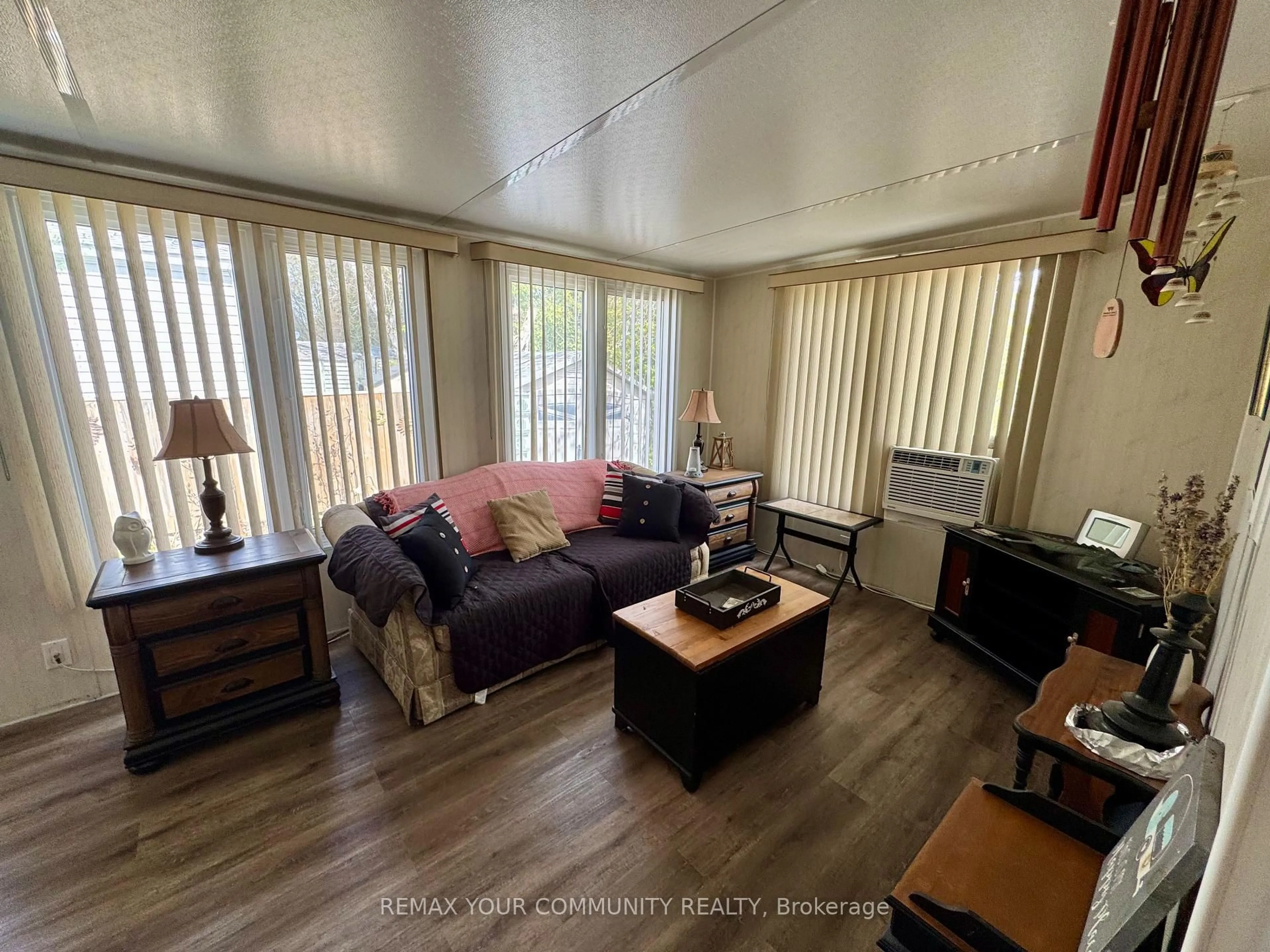 Living room with furniture, wood/laminate floor for 285 Crydermans Sdrd #323, Georgina Ontario L0E 1A0