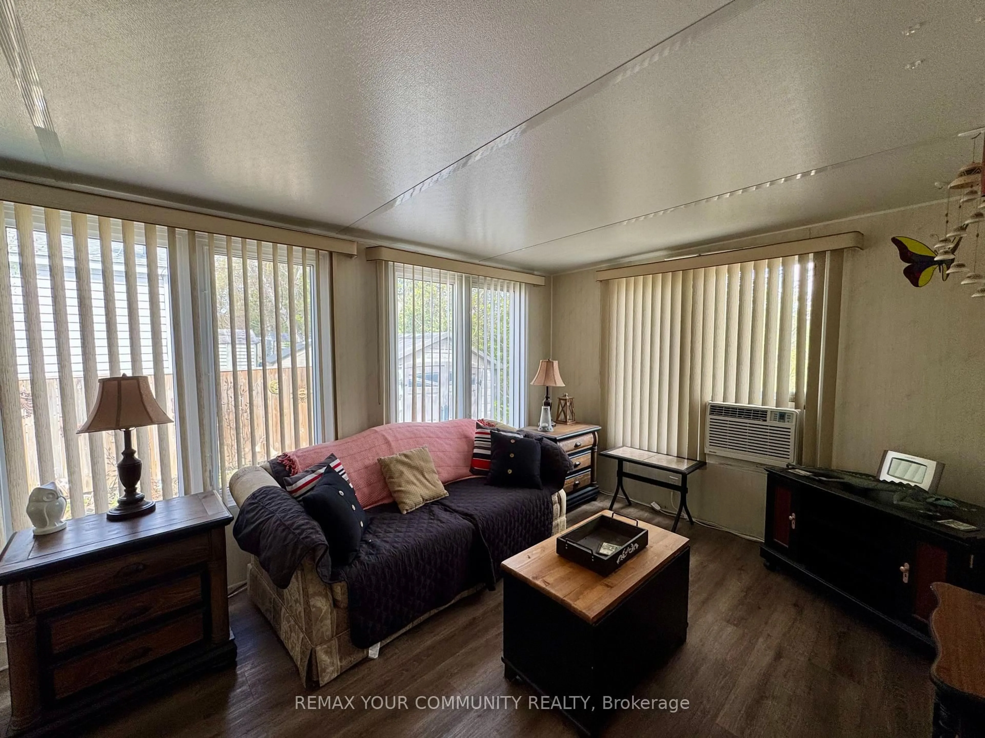 Living room with furniture, wood/laminate floor for 285 Crydermans Sdrd #323, Georgina Ontario L0E 1A0