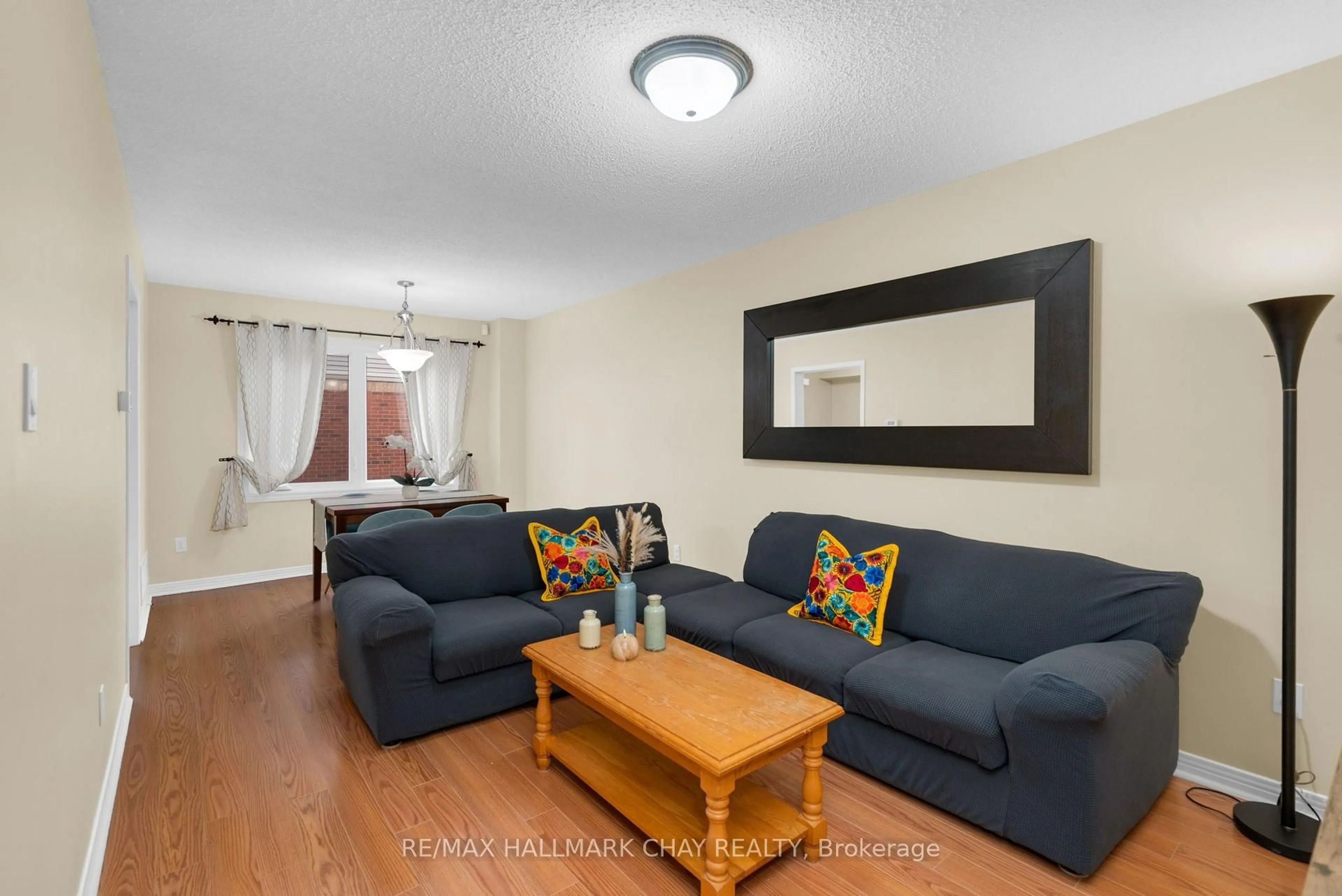Living room with furniture, wood/laminate floor for 769 Playter Cres, Newmarket Ontario L3X 1W7