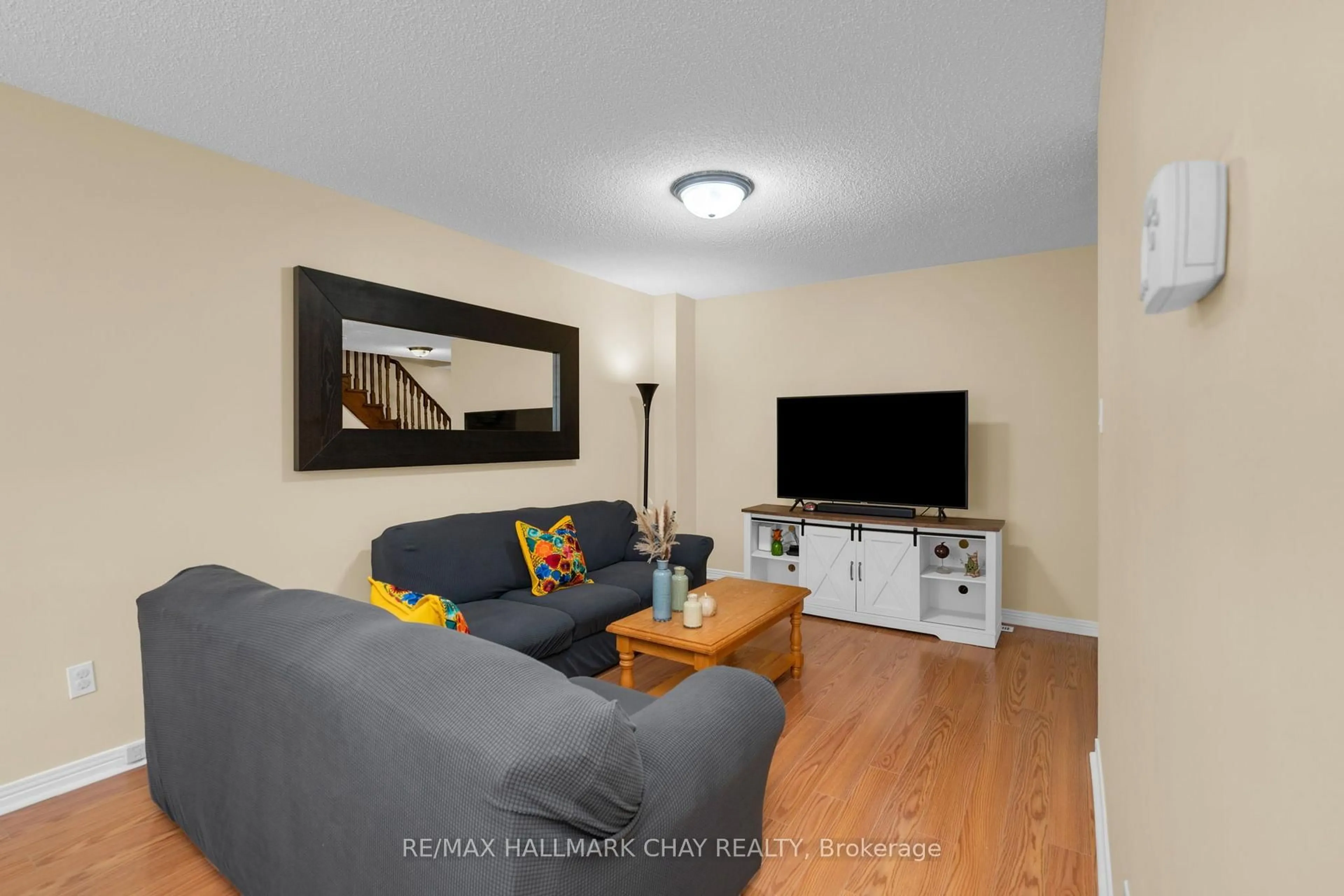 Living room with furniture, wood/laminate floor for 769 Playter Cres, Newmarket Ontario L3X 1W7