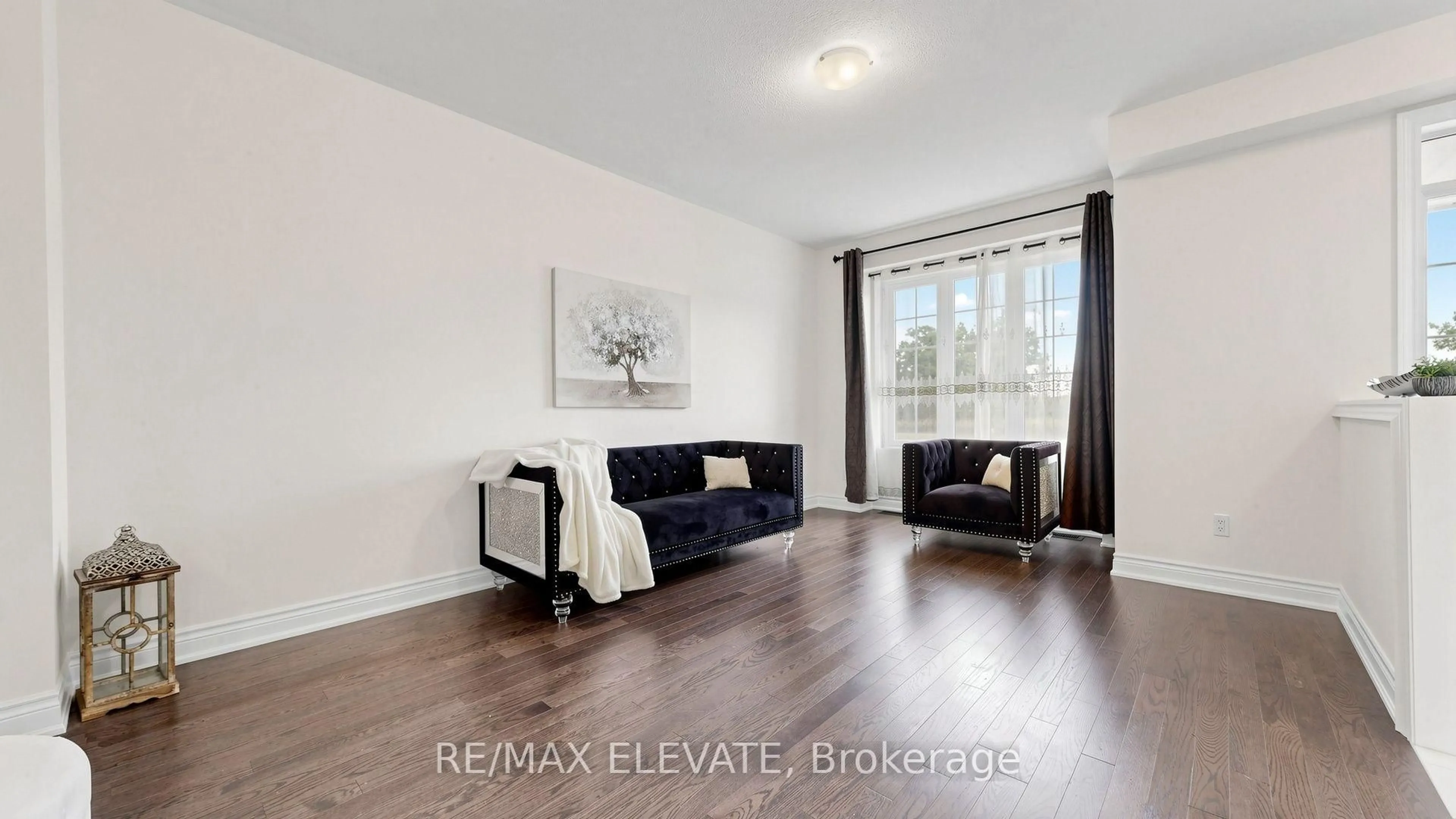 Living room with furniture, wood/laminate floor for 265 Kirkham Dr, Markham Ontario L3S 0A9