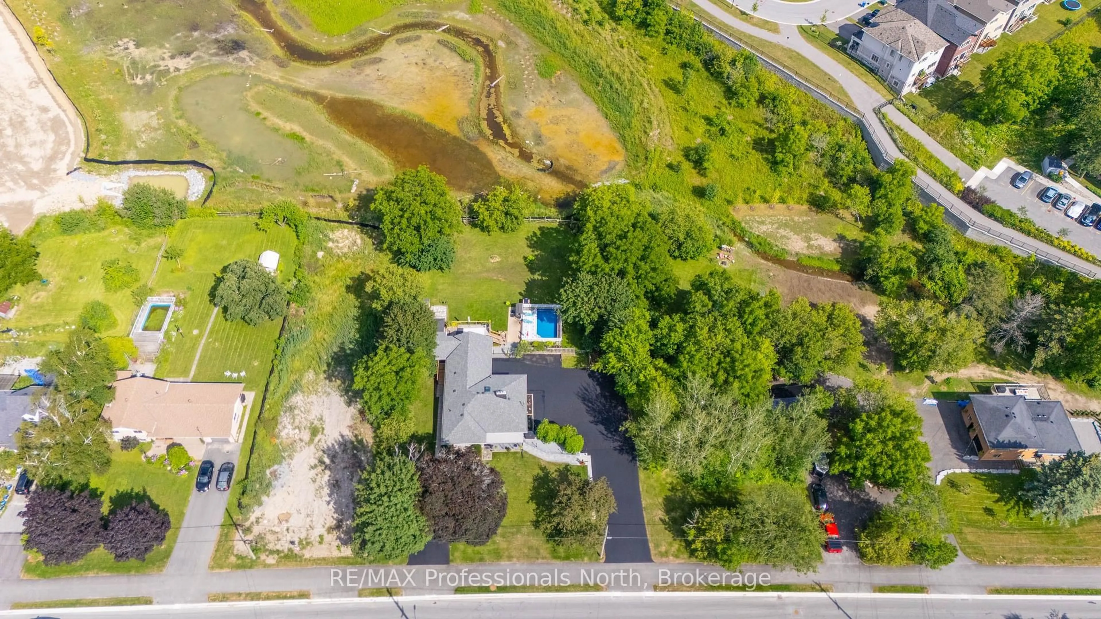 A pic from outside/outdoor area/front of a property/back of a property/a pic from drone, water/lake/river/ocean view for 63 The Queensway, Georgina Ontario L4P 0L2