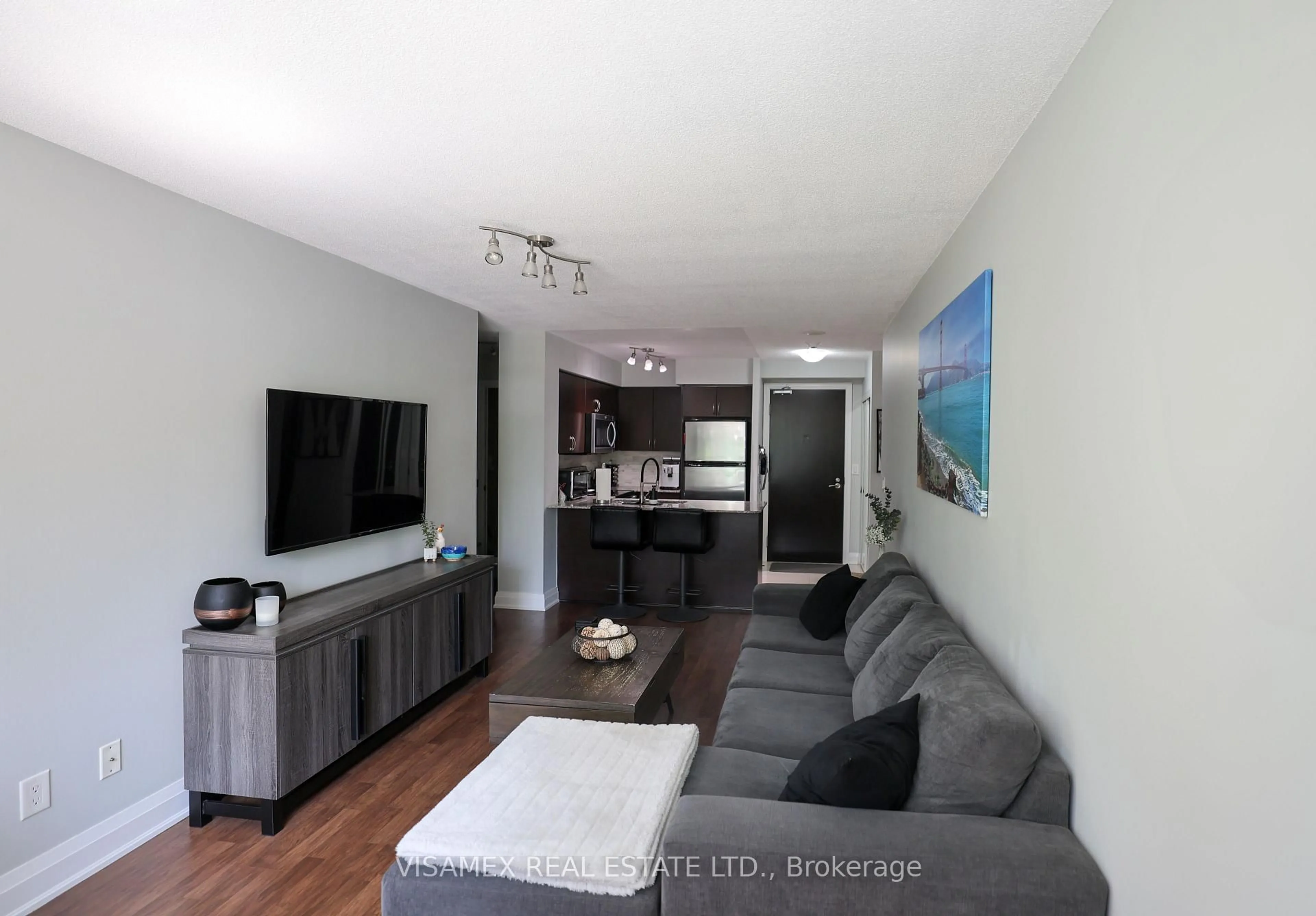Living room with furniture, wood/laminate floor for 20 North Park Rd #210, Vaughan Ontario L4J 0G7